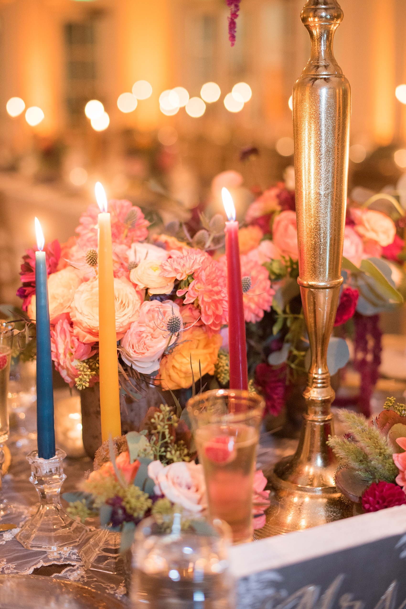 Mikkel Paige Photography photos from a Merrimon-Wynne House wedding in Raleigh. The reception was drenched in romantic candlelight, inside the Carriage House. Tables were decorated with fall flower centerpieces and colorful tapered candles by Meristem Floral.