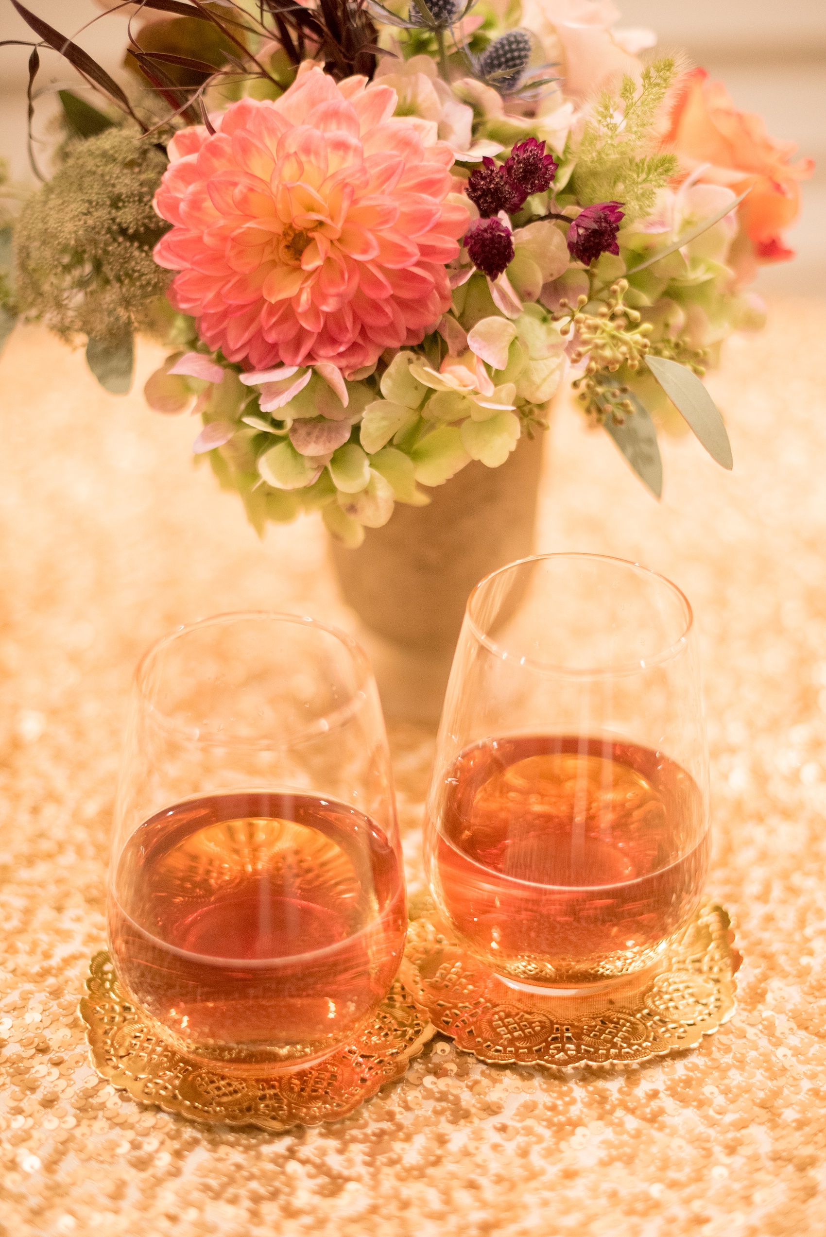 Mikkel Paige Photography photos from a Merrimon-Wynne House wedding in Raleigh. Gold doilies were used as coasters during a candlelight reception in the Carriage House.