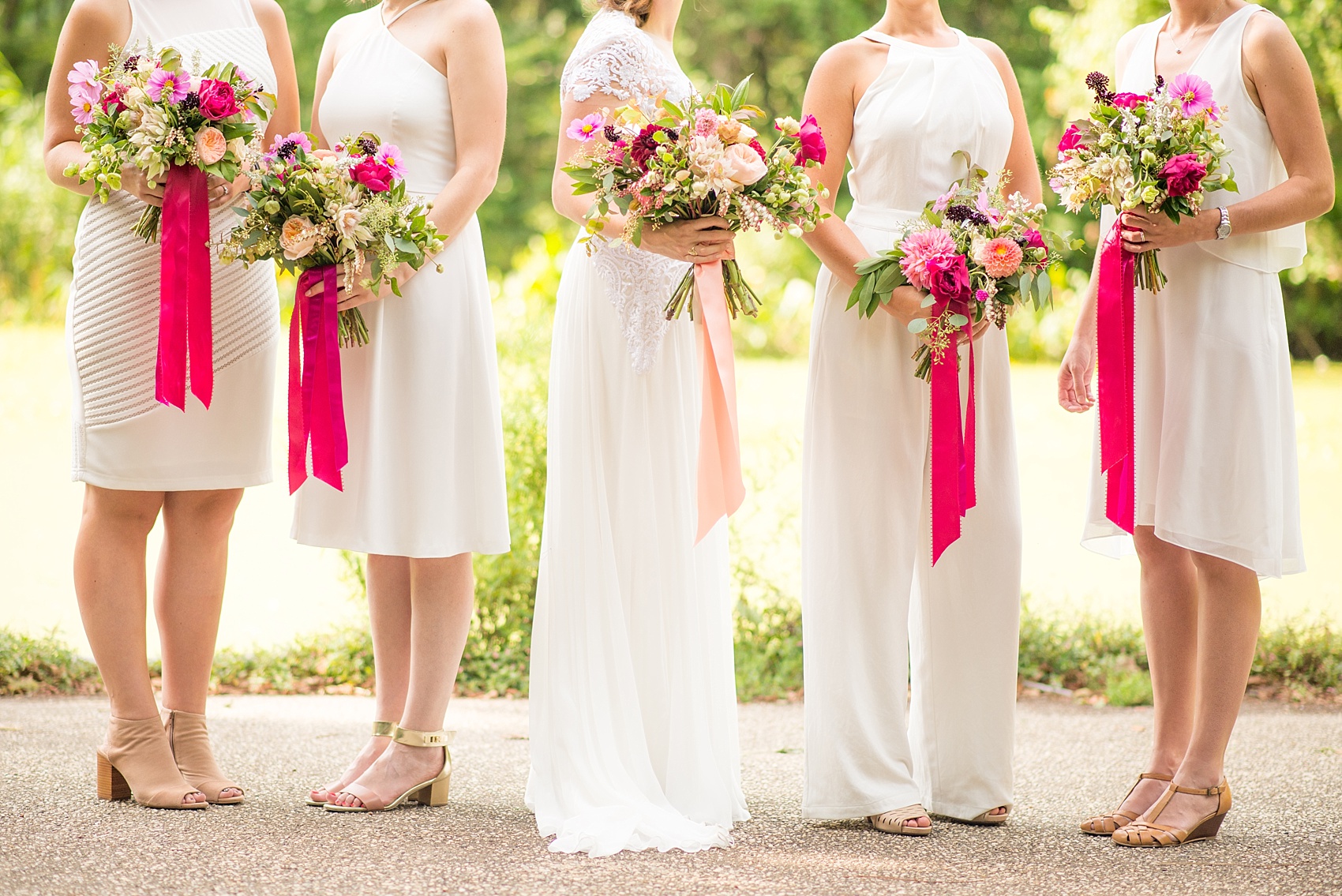 Mikkel Paige Photography photos of an all-white dressed bridal party with pink floral accents for a wedding at Prospect Park Boathouse in Brooklyn, NY. Flowers by Sachi Rose and bride's gown by Reem Acra.
