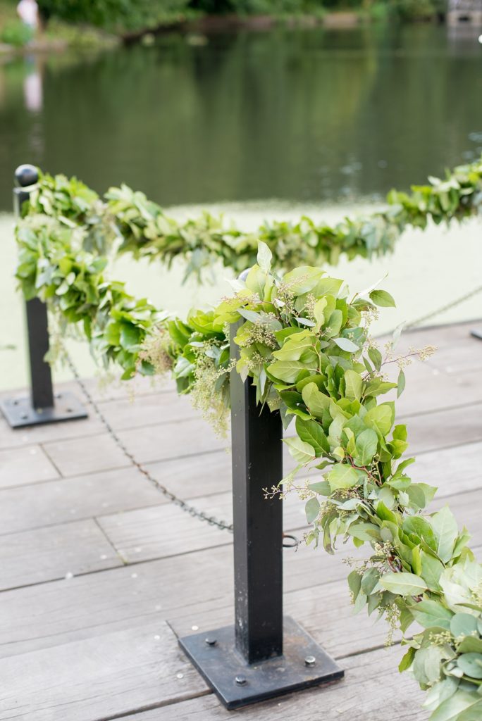 Mikkel Paige Photography photo of outdoor ceremony floral garland at a Prospect Park Boathouse, NYC wedding.