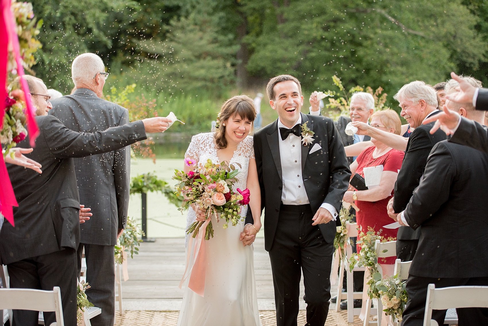 Mikkel Paige Photography photo of an outdoor ceremony at a Prospect Park Boathouse wedding. The bride and groom exit with a lavender toss!