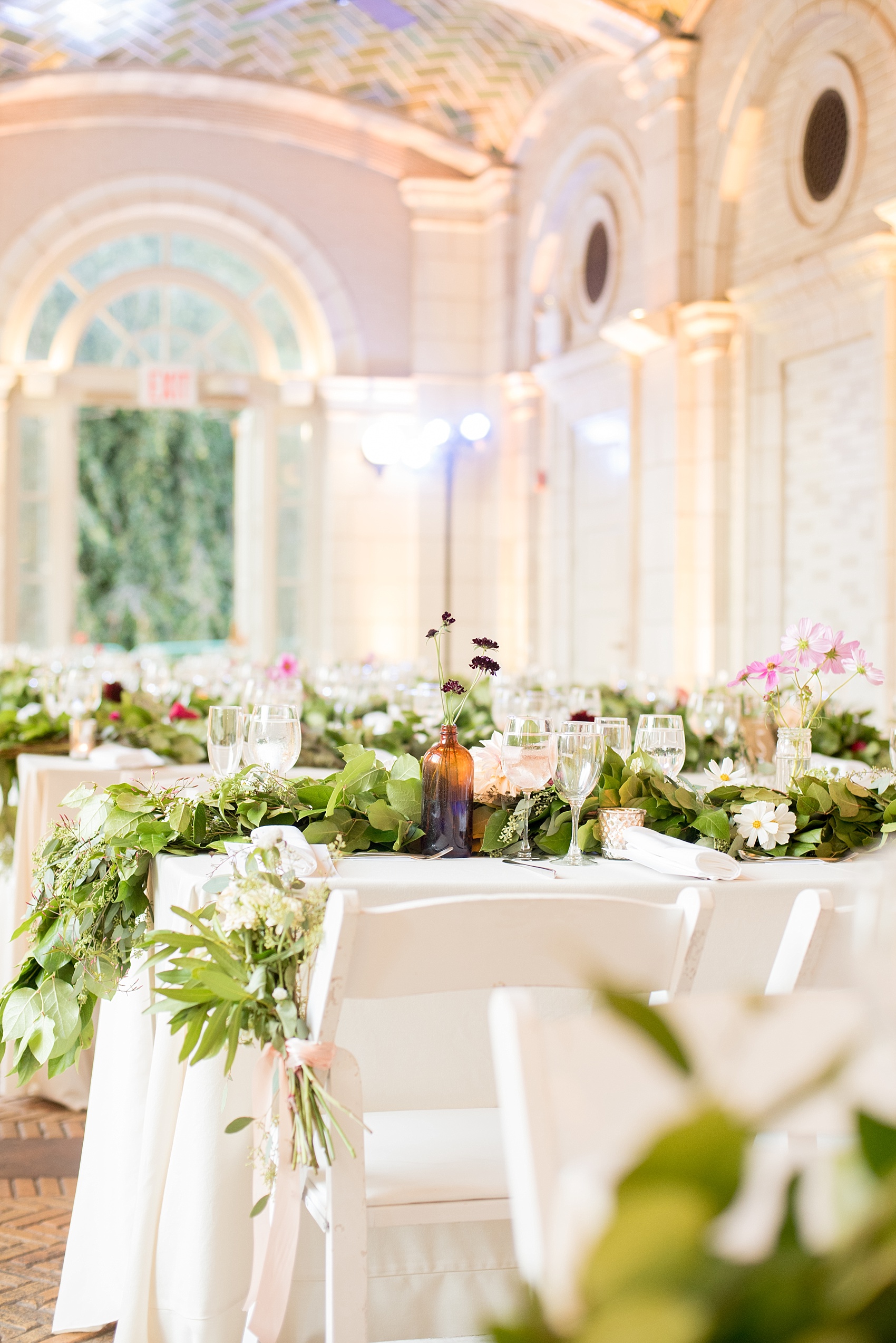 Mikkel Paige Photography photos of a wedding at Brooklyn's Prospect Park Boathouse with floral garland by Sachi Rose.