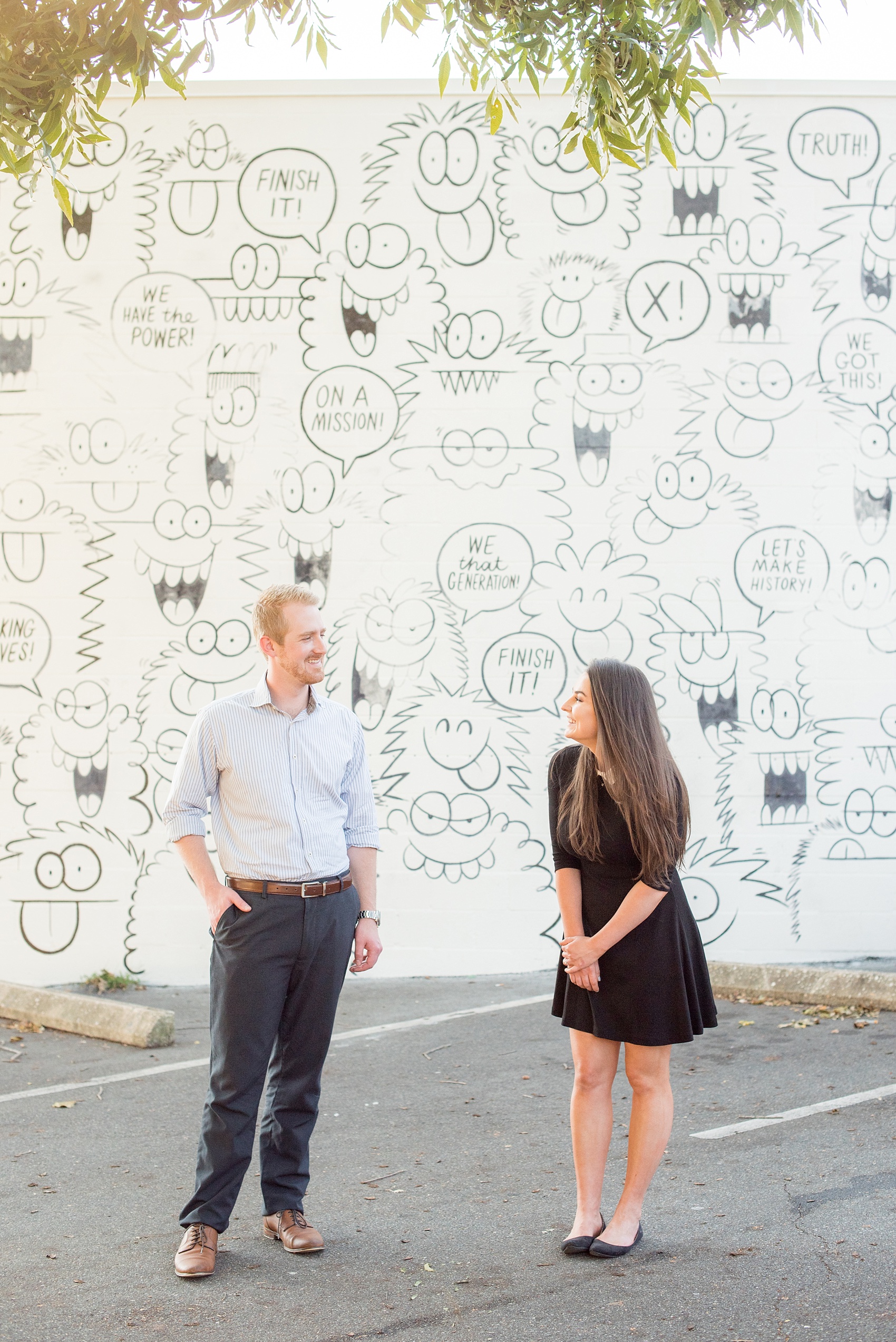 Mikkel Paige Photography photos of a downtown Raleigh engagement session with comical, fun murals.