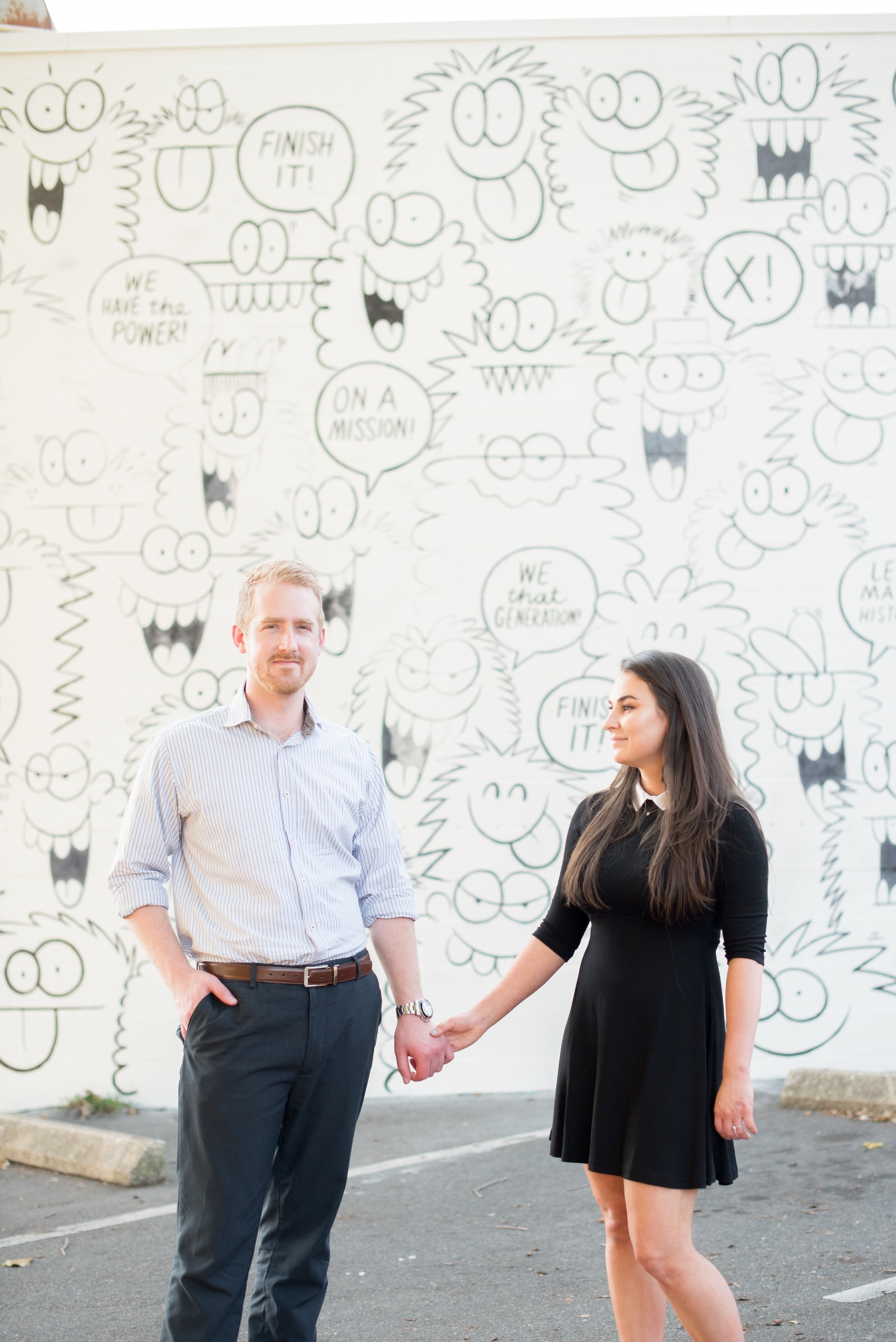 Mikkel Paige Photography photos of a downtown Raleigh engagement session with comical, fun murals.