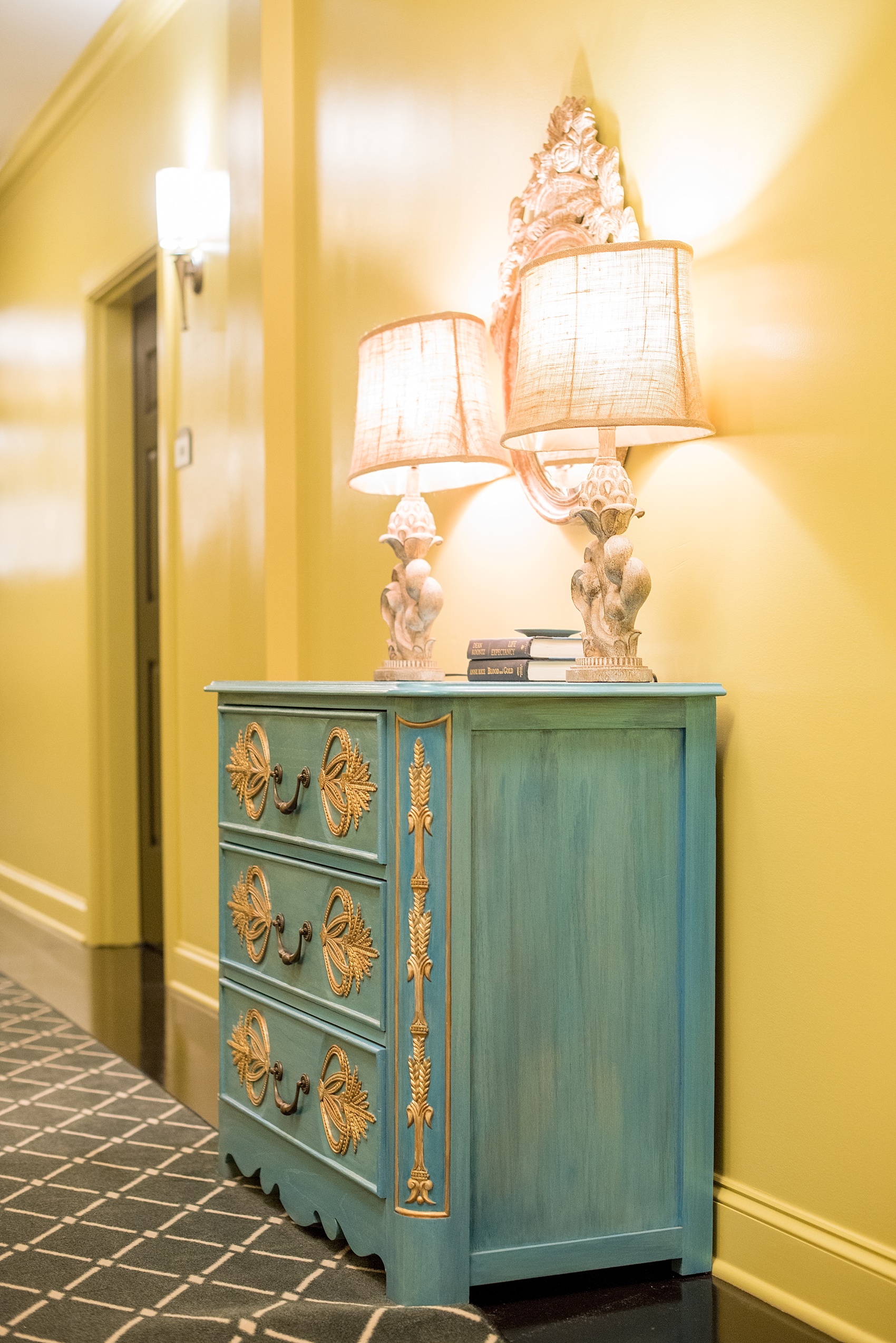 Mikkel Paige Photography, Raleigh wedding photographer, photos of The Mayton Inn hotel and venue in Cary, NC. Yellow hallways blue dresser detail images.