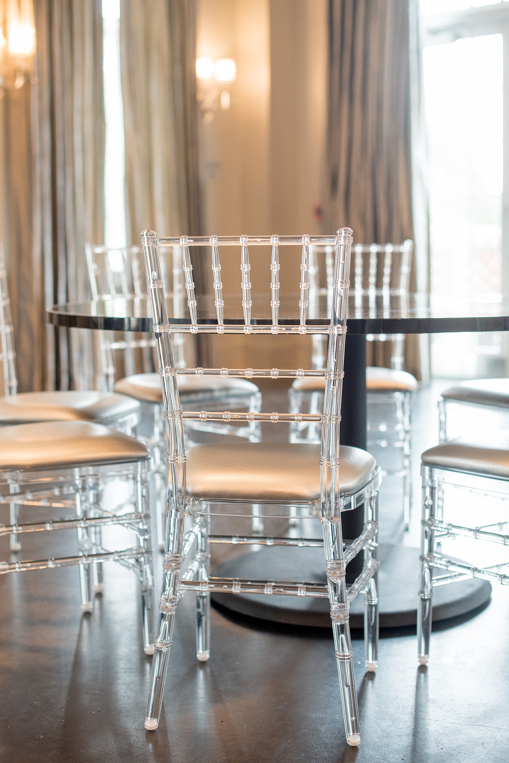 Mikkel Paige Photography, Raleigh wedding photographer, photos of The Mayton Inn hotel and venue in Cary, NC. Ballroom image with clear Chiavari chairs and grey curtains.