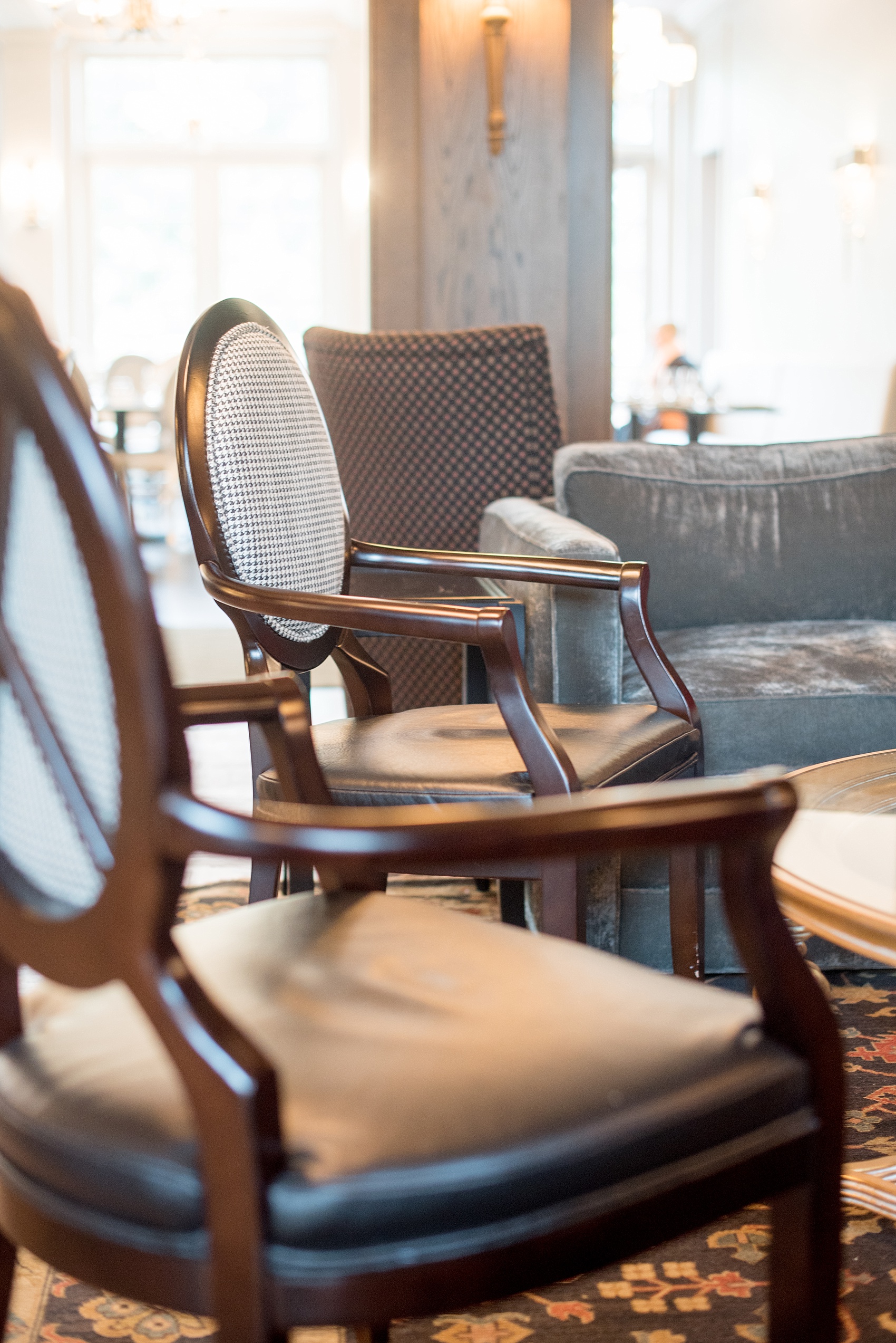 Mikkel Paige Photography, Raleigh wedding photographer, photos of The Mayton Inn hotel and venue in Cary, NC. Sitting room detail with upholstered chairs with black and white fabric houndstooth detail.