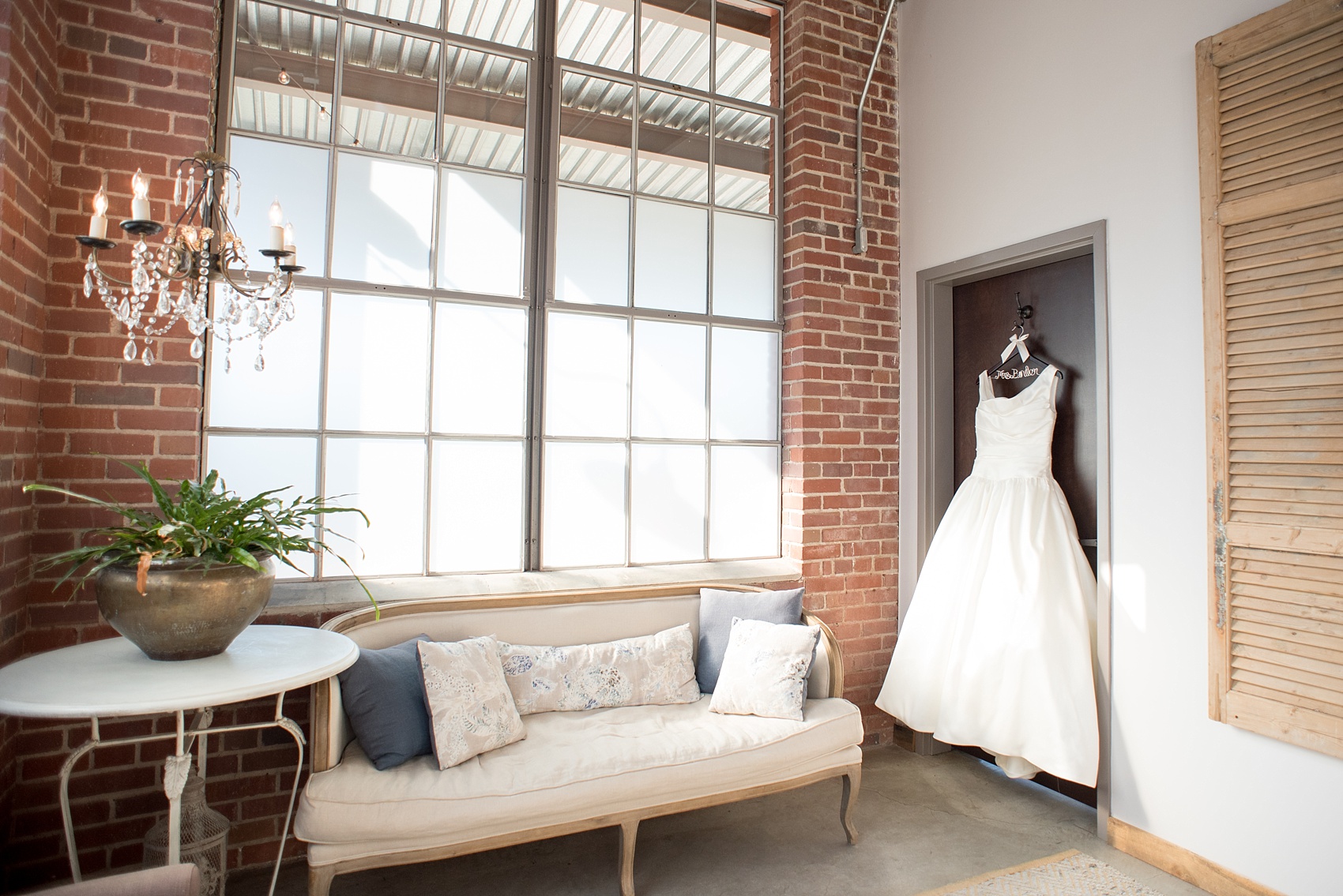 Mikkel Paige Photography photo of a wedding at The Rickhouse, Durham. The bride's white gown hangs in the bridal suite.