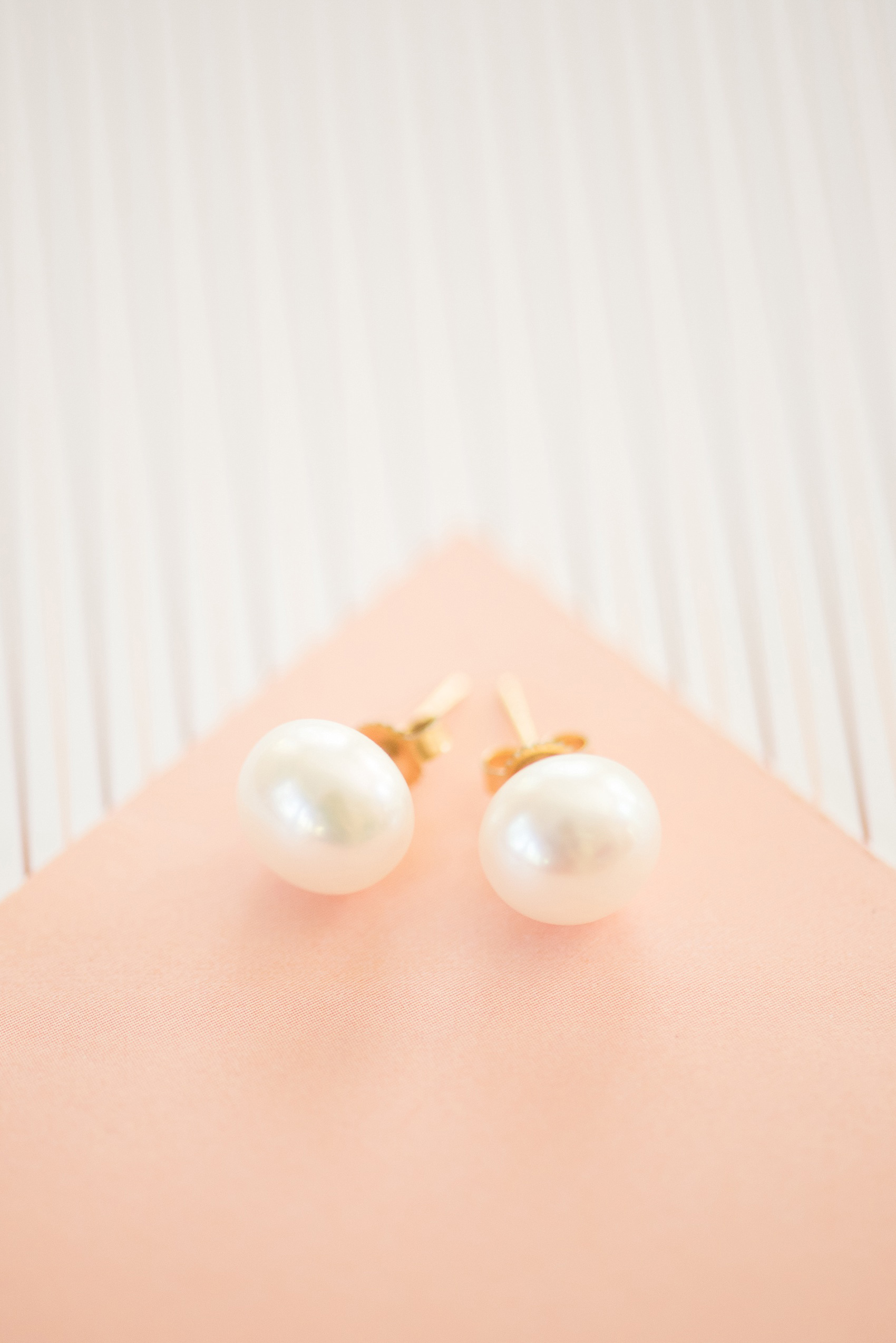 Mikkel Paige Photography photo of a wedding at The Rickhouse, Durham. A detail image of the bride's pearl earring studs.