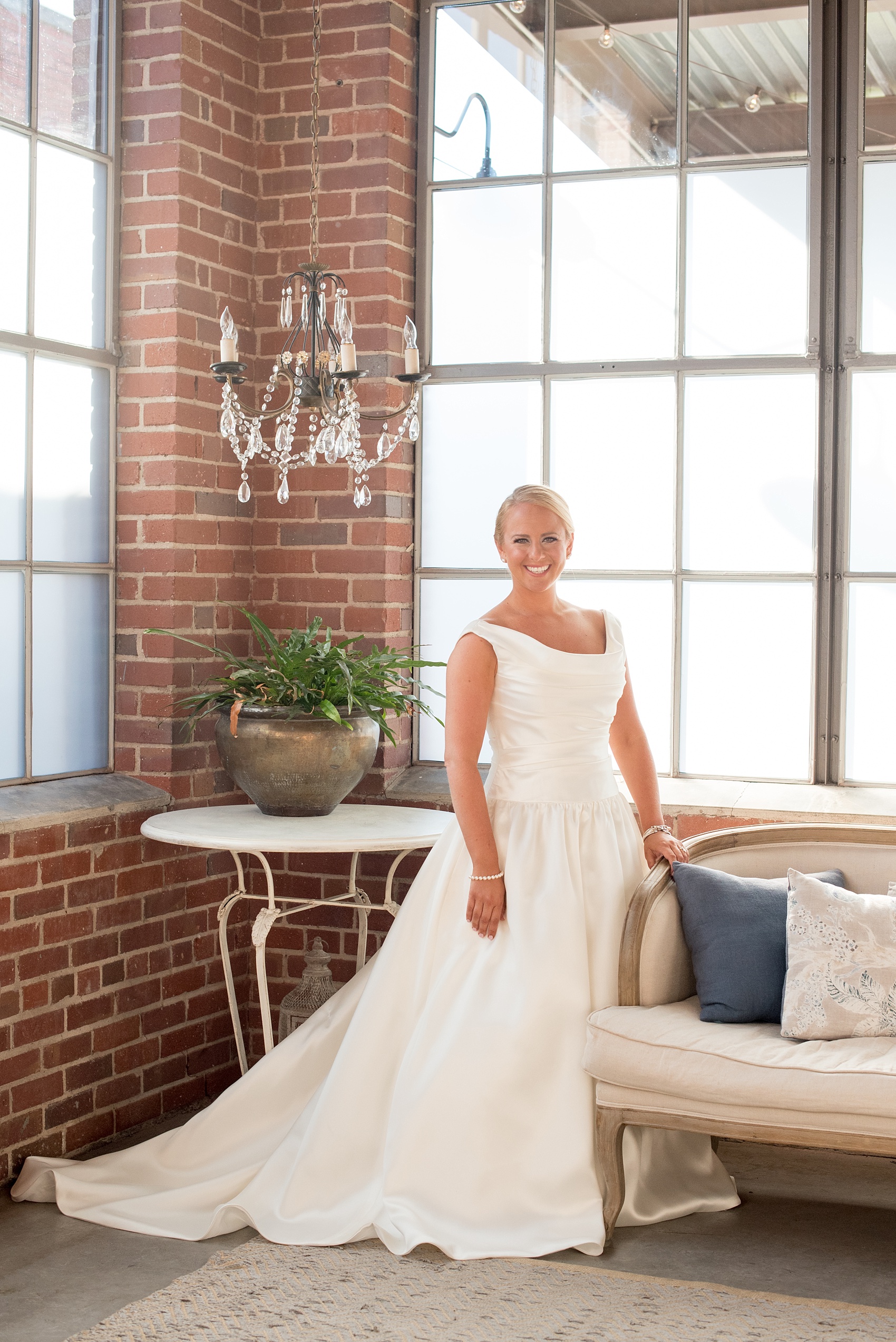 Mikkel Paige Photography photo of a wedding at The Rickhouse, Durham. The bride takes an iconic portrait in the bridal suite.