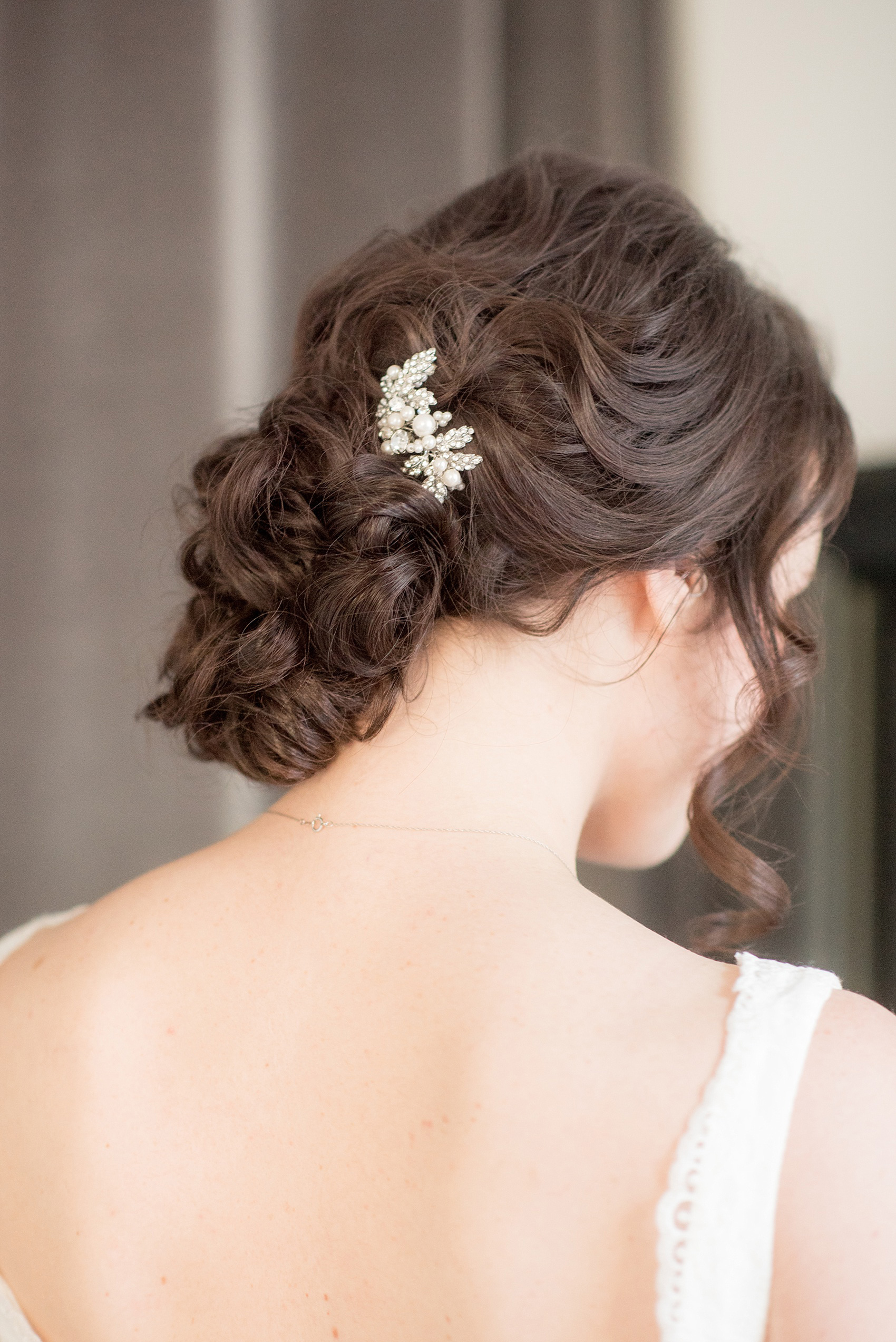 Mikkel Paige Photography photo of a bride in The White Room in downtown Raleigh for a North Carolina wedding. Her hair was pulled up in a pin-up curl do with a rhinestone comb.