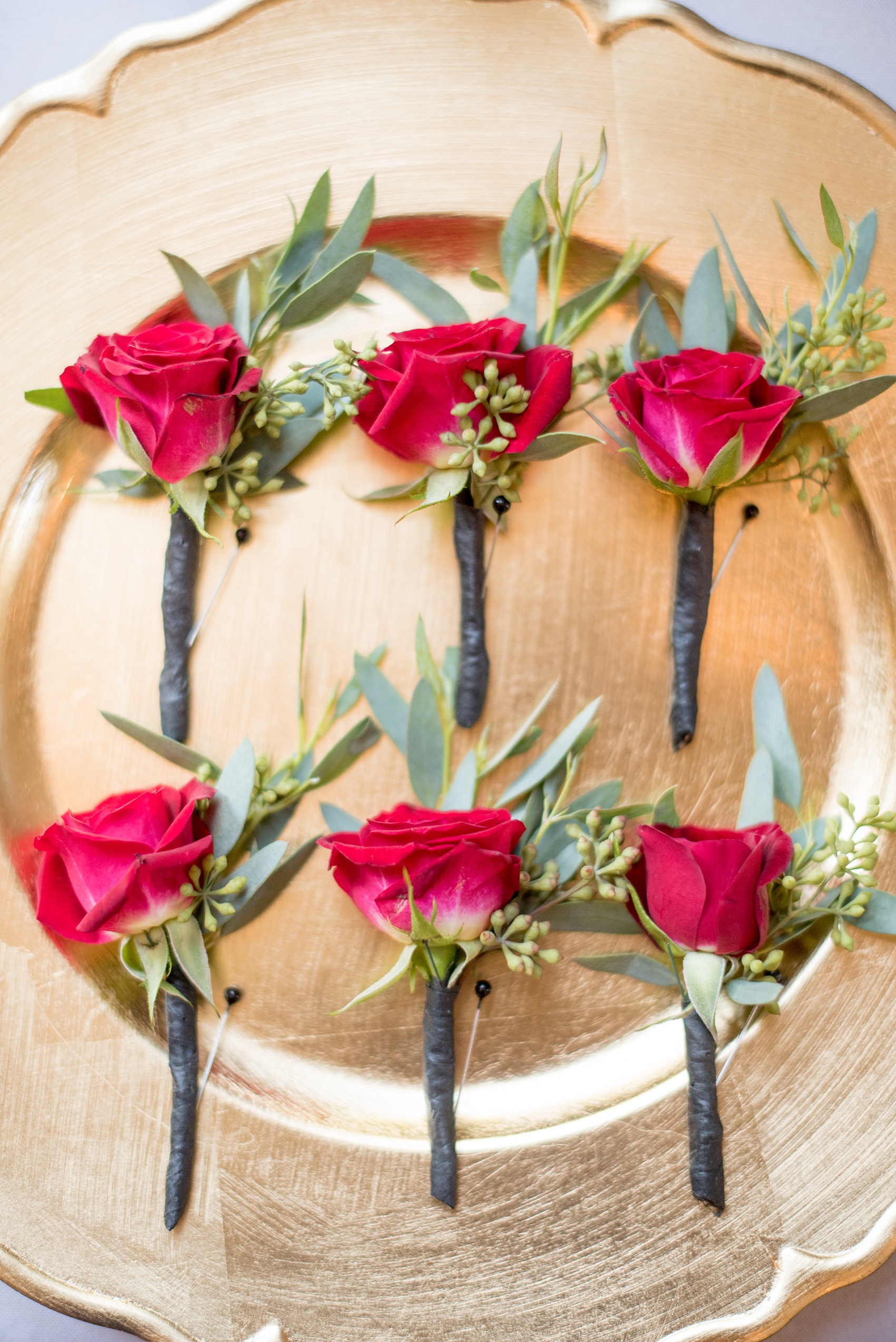 Mikkel Paige Photography photo of red rose and eucalyptus boutonnieres for a 214 Martin Street wedding.
