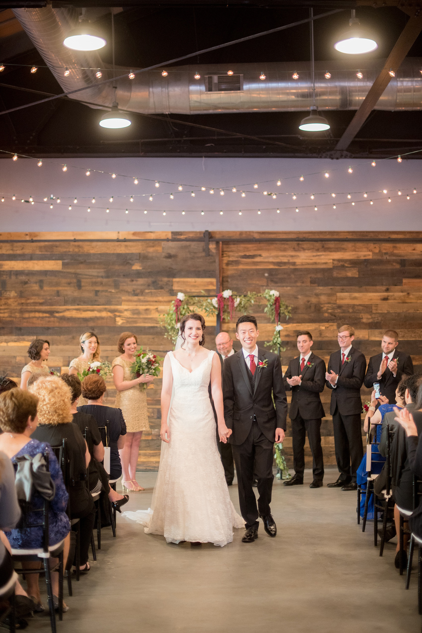 Mikkel Paige Photography photos from a wedding at 214 Martin Street in downtown Raleigh with an indoor ceremony and bistro market lights.