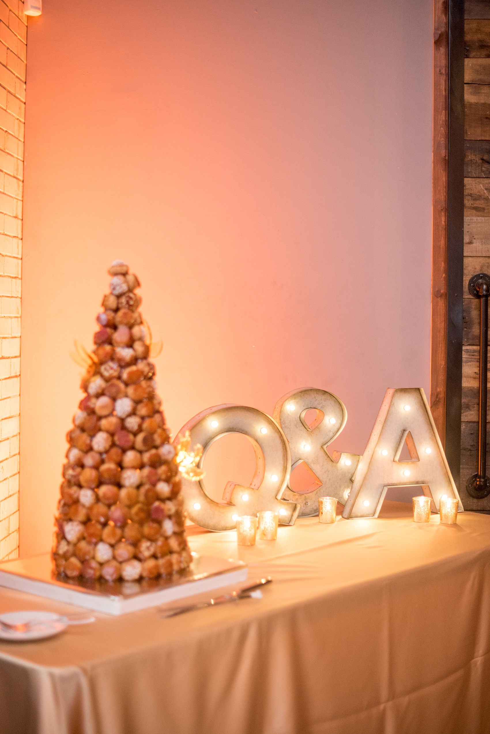 Mikkel Paige Photography photos from a wedding at 214 Martin Street in downtown Raleigh. Dessert table with a traditional french Croquembouche by LucetteGrace.