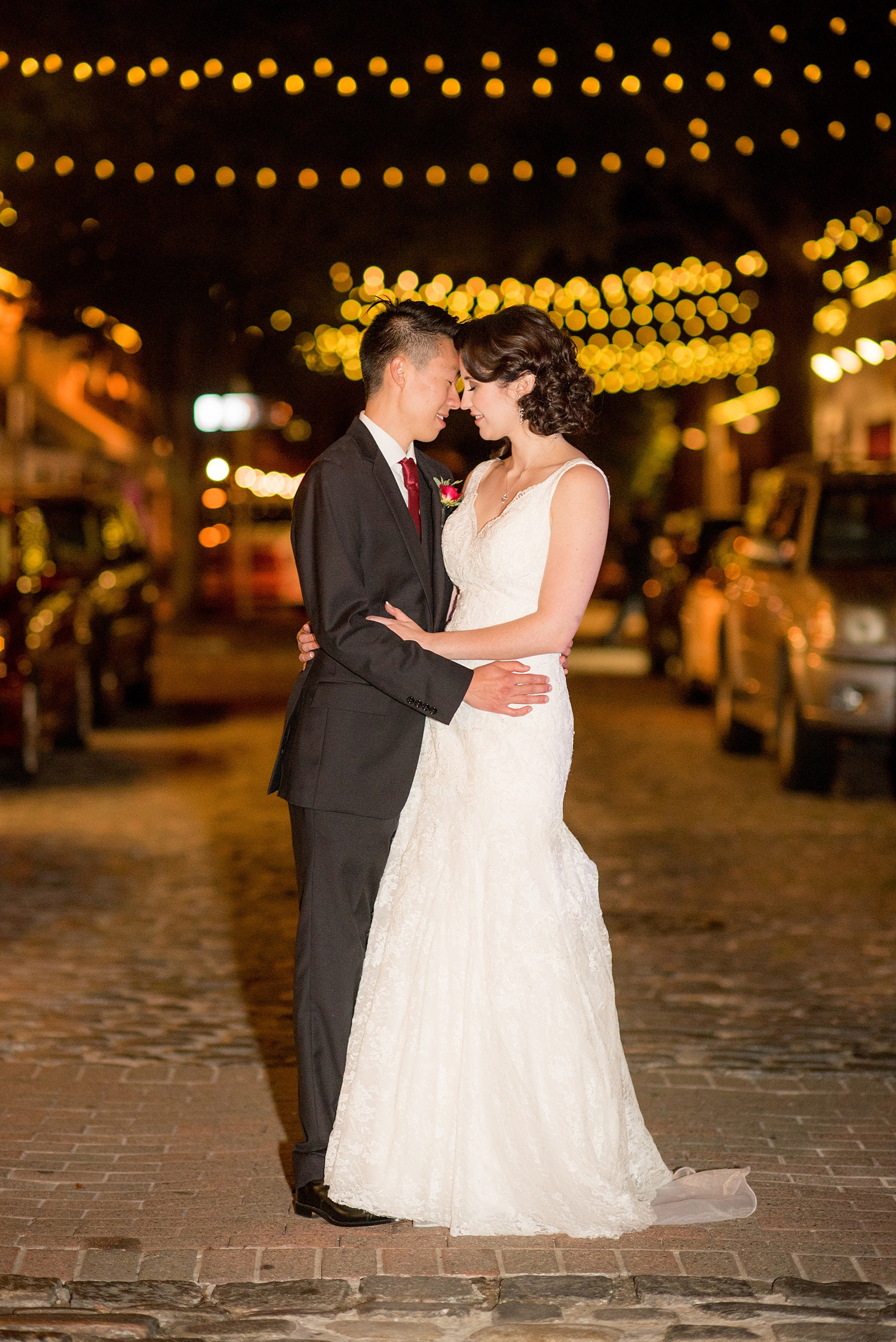 Mikkel Paige Photography photos from a wedding at 214 Martin Street in downtown Raleigh. Picture of the bride and groom at night with market bistro lights.