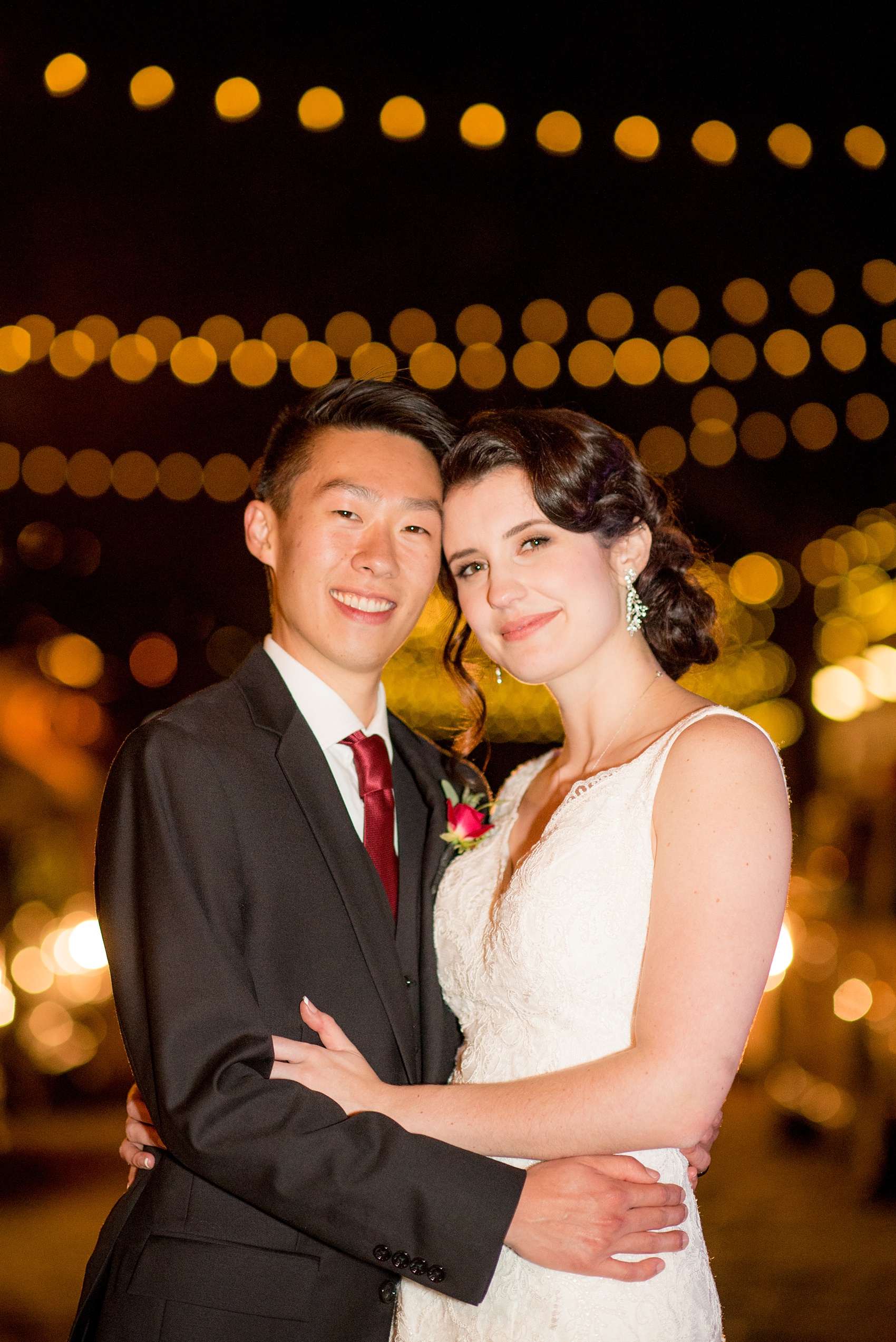 Mikkel Paige Photography photos from a wedding at 214 Martin Street in downtown Raleigh. Picture of the bride and groom at night with market bistro lights.