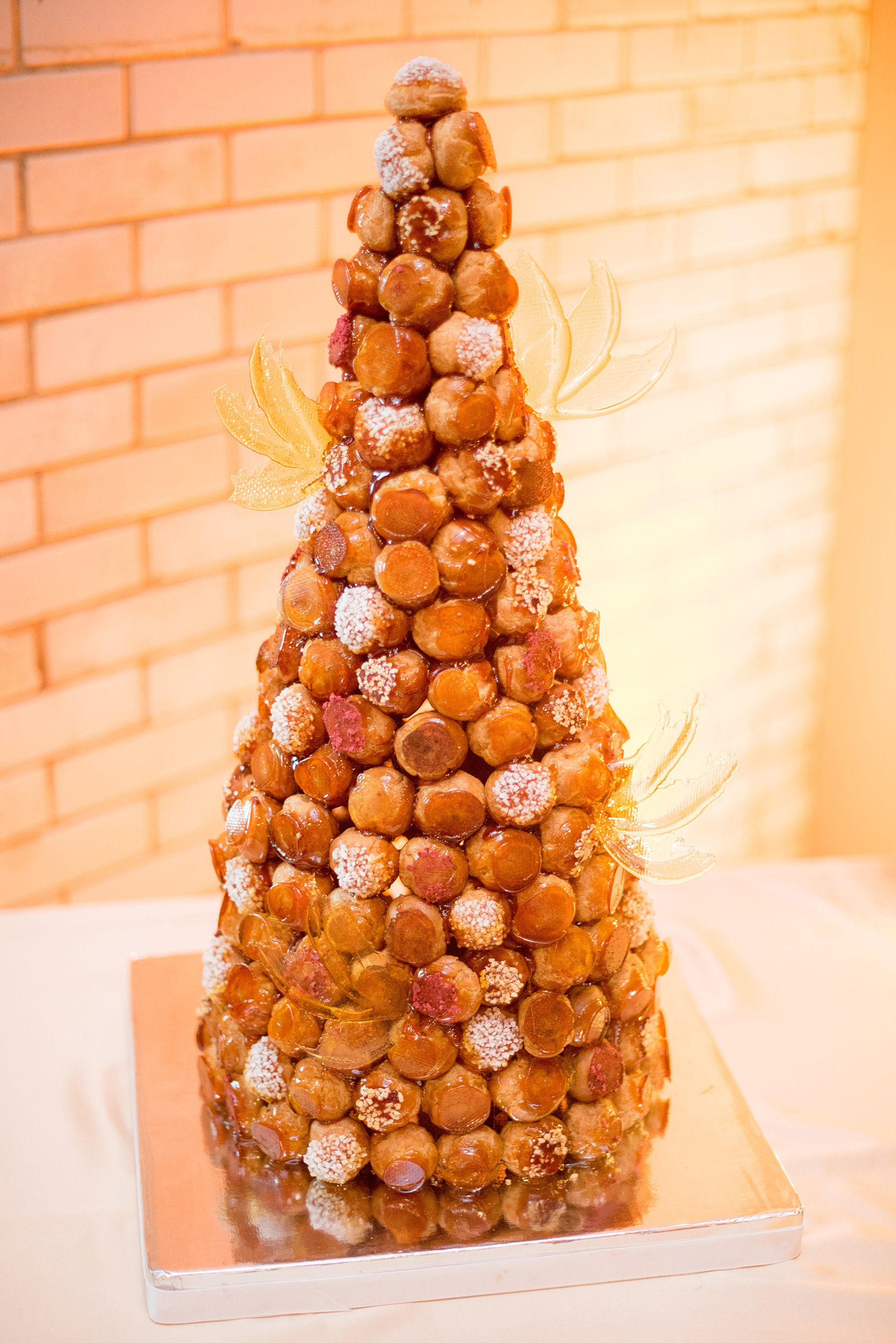 Mikkel Paige Photography photos from a wedding at 214 Martin Street in downtown Raleigh. Dessert table with a traditional french Croquembouche by LucetteGrace.