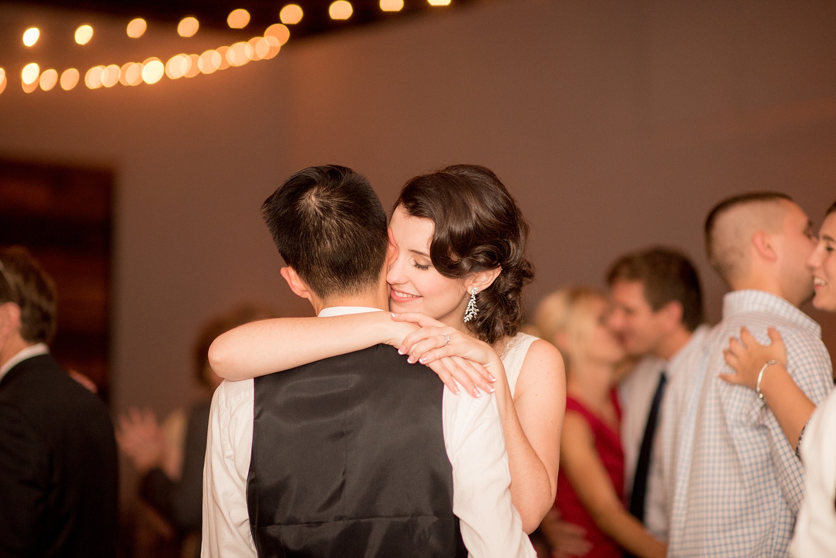 Mikkel Paige Photography photos from a wedding at 214 Martin Street in downtown Raleigh. Picture of the bride and groom dancing at their reception.