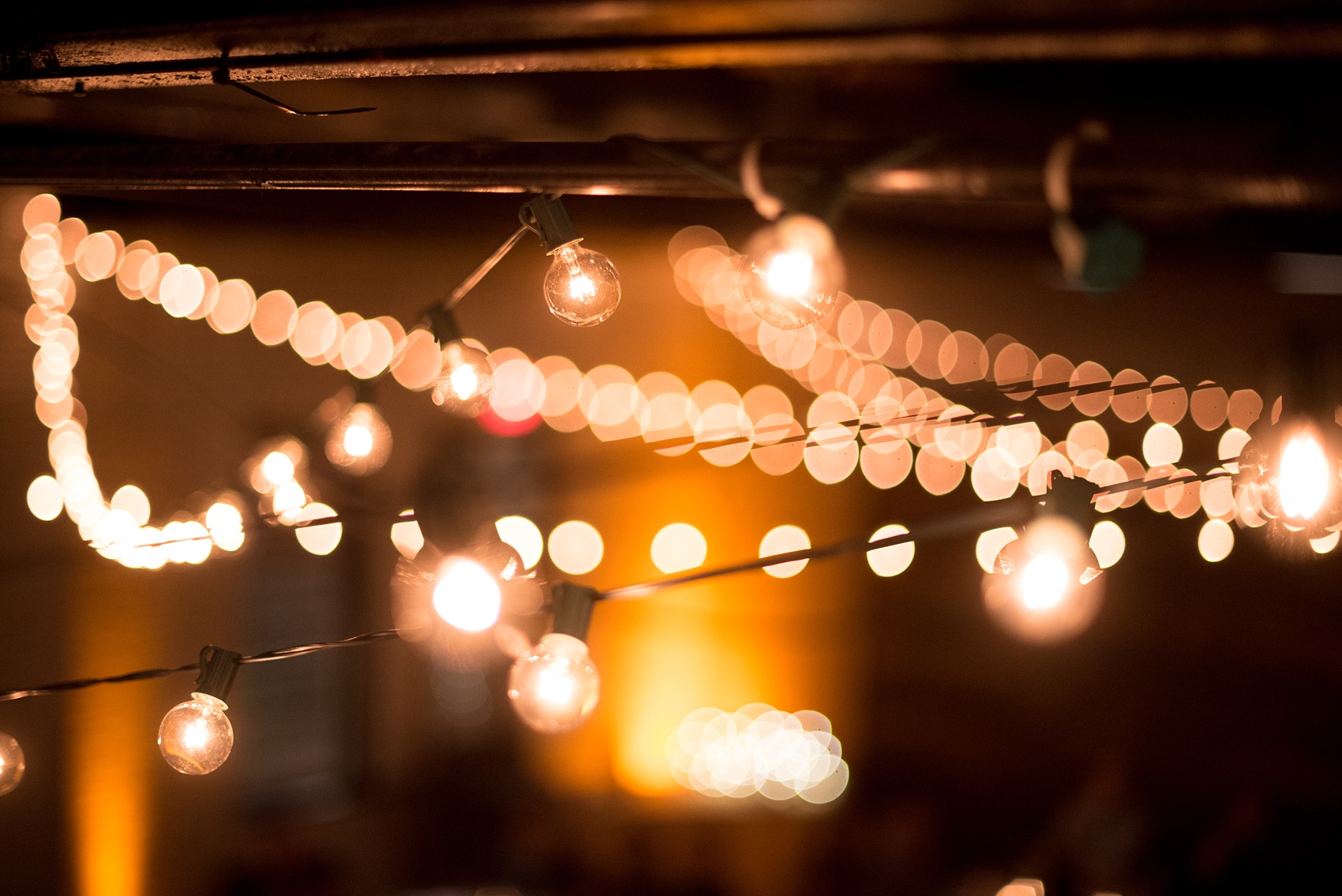 Mikkel Paige Photography photos from a wedding at 214 Martin Street in downtown Raleigh. Picture of the bistro market lights at the evening reception.