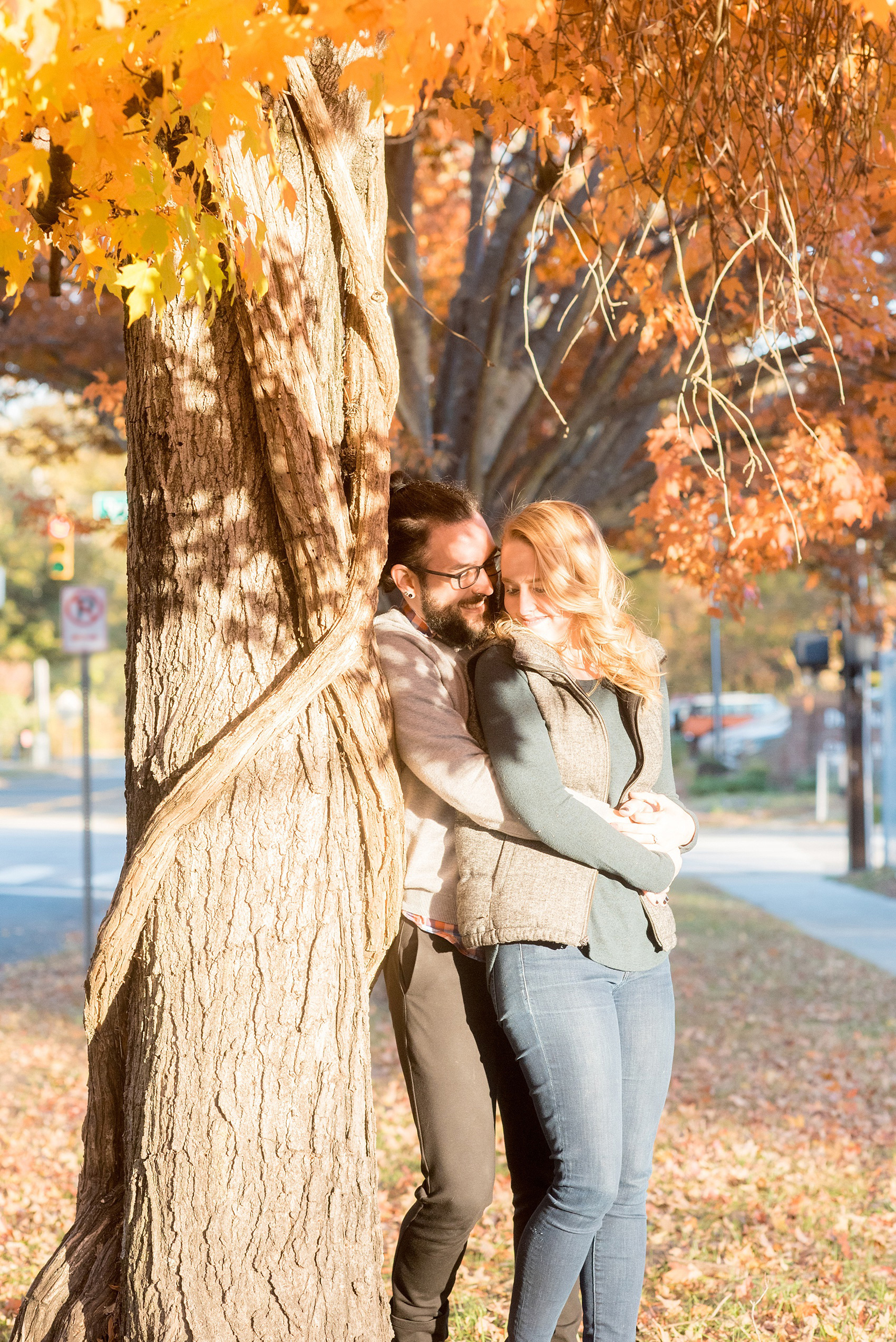 Mikkel Paige Photography photos of a downtown Durham engagement session with a fall leaves and cozy outfits.