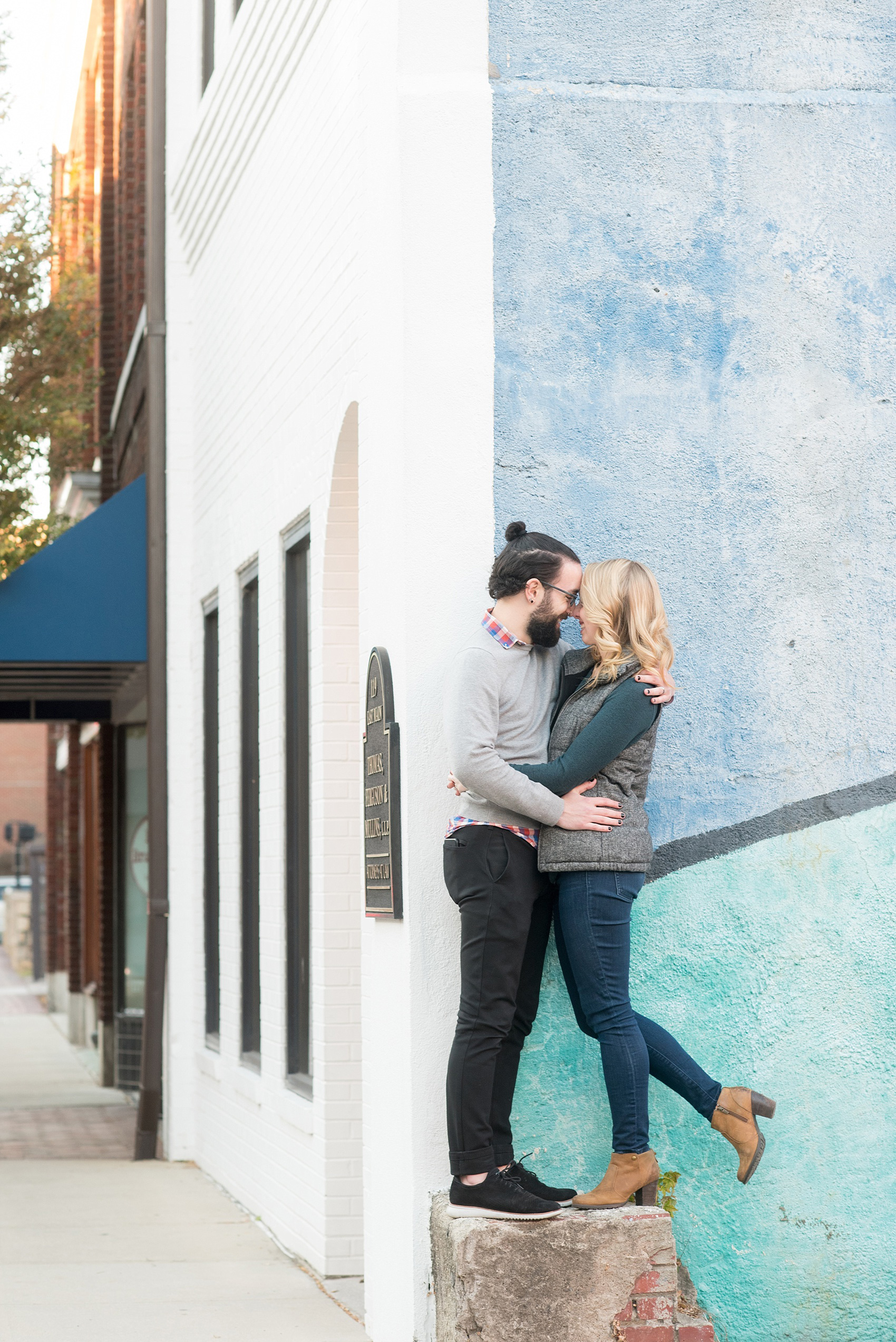 Mikkel Paige Photography photos of a Durham engagement session in downtown Durham. The couple wore cozy fall outfits.