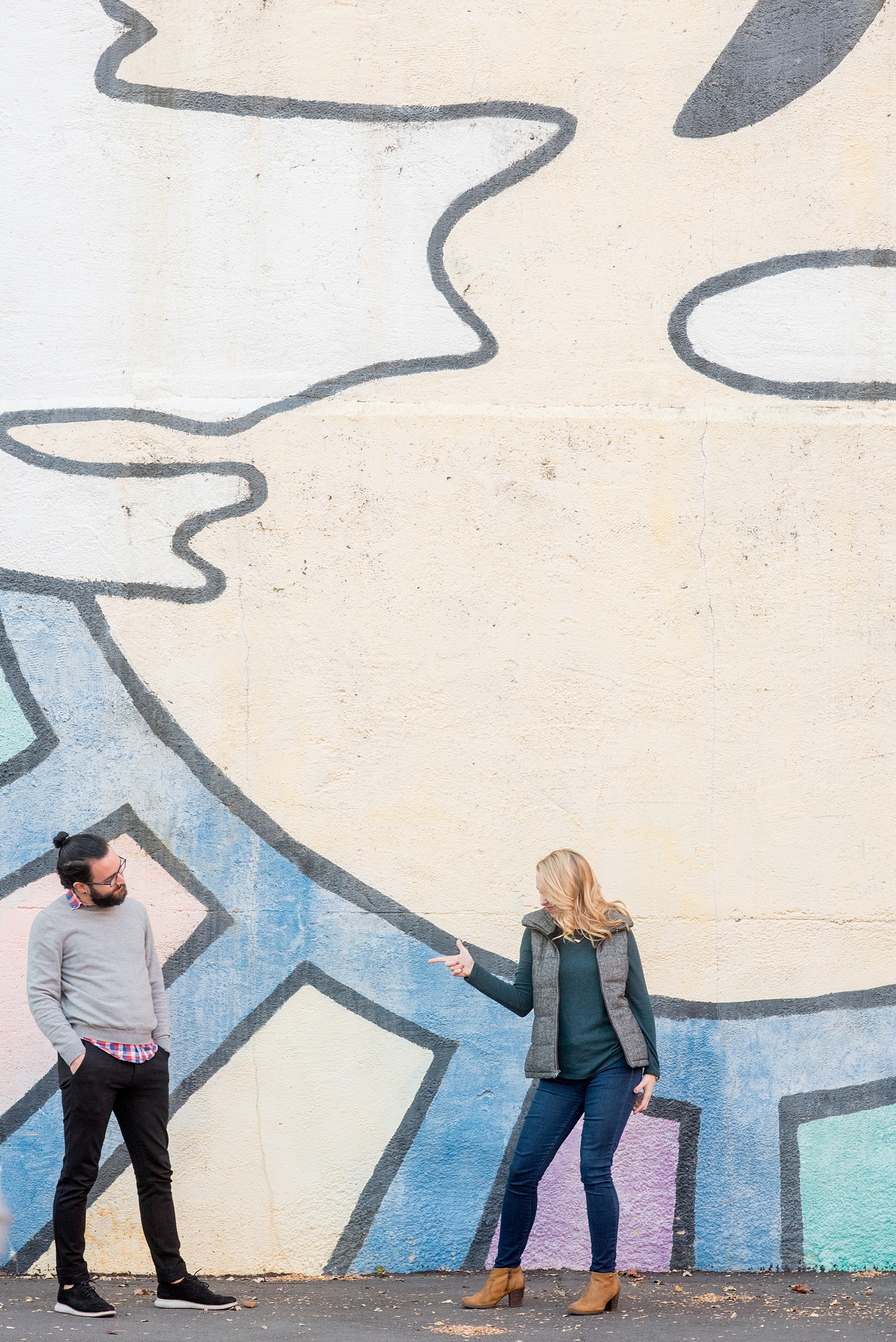 Mikkel Paige Photography photos of a Durham engagement session in downtown Durham against a colorful sun mural.