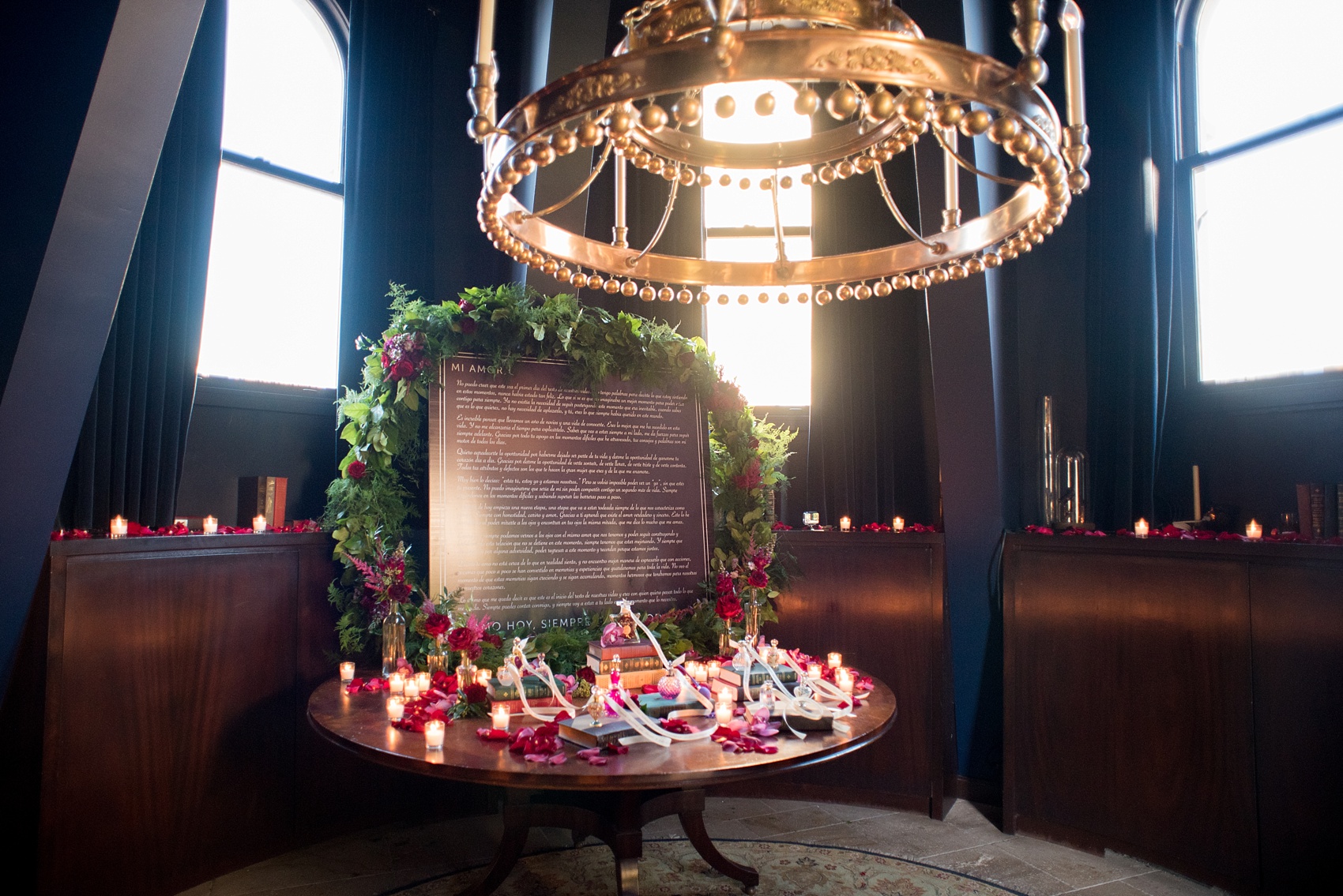 Mikkel Paige Photography photos of a NYC proposal at The Nomad Hotel. The Arrangement presented gorgeous red and pink flowers for a romantic candlelight proposal planned by Brilliant Event Planning.