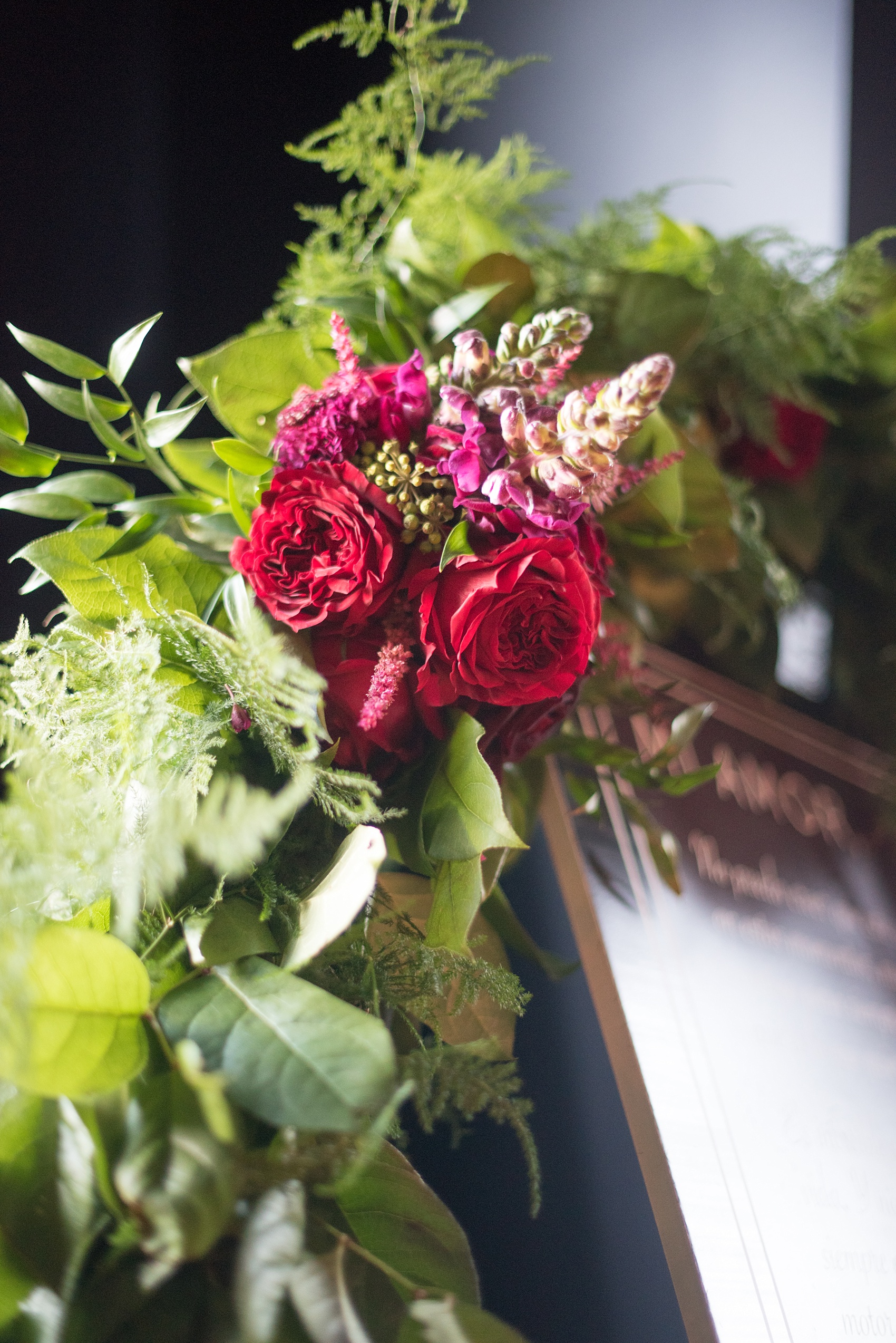 Mikkel Paige Photography photos of a NYC proposal at The Nomad Hotel. The Arrangement presented gorgeous red and pink flowers for a romantic candlelight proposal planned by Brilliant Event Planning.