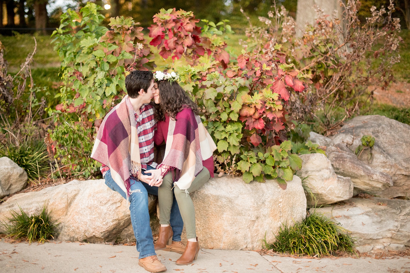 Mikkel Paige Photography photos of a Raleigh engagement session at Pullen Park. The bride and groom got cozy in a burgundy plaid blanket.