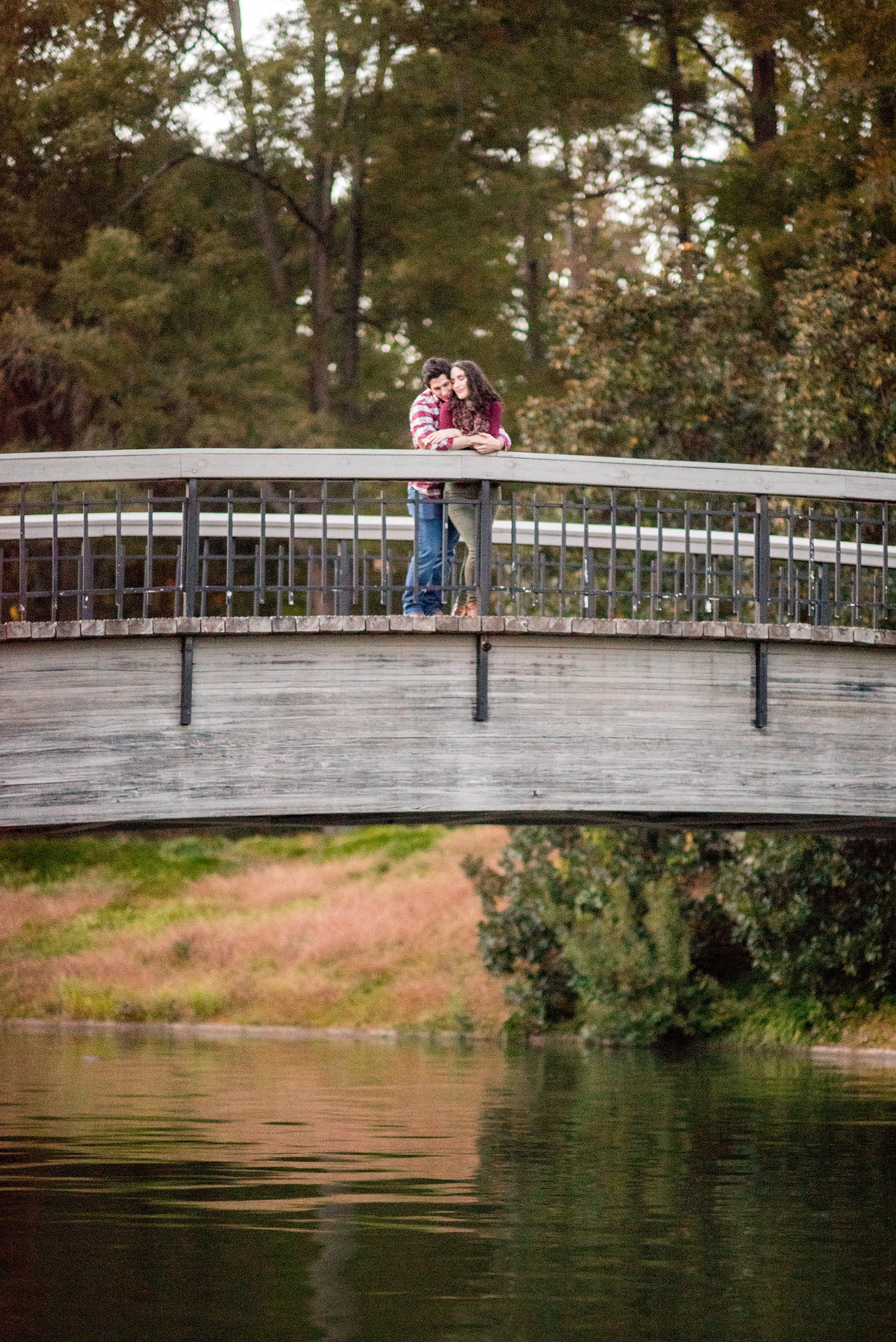 Mikkel Paige Photography photos of a Raleigh engagement session on a bridge at Pullen Park.