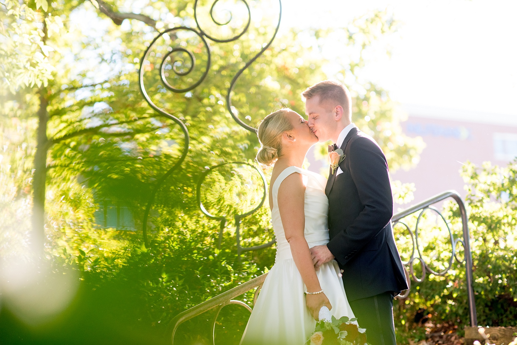 Mikkel Paige Photography photo of a wedding at The Rickhouse, North Carolina. The bride and groom kiss in Durham Central Park after their first look!