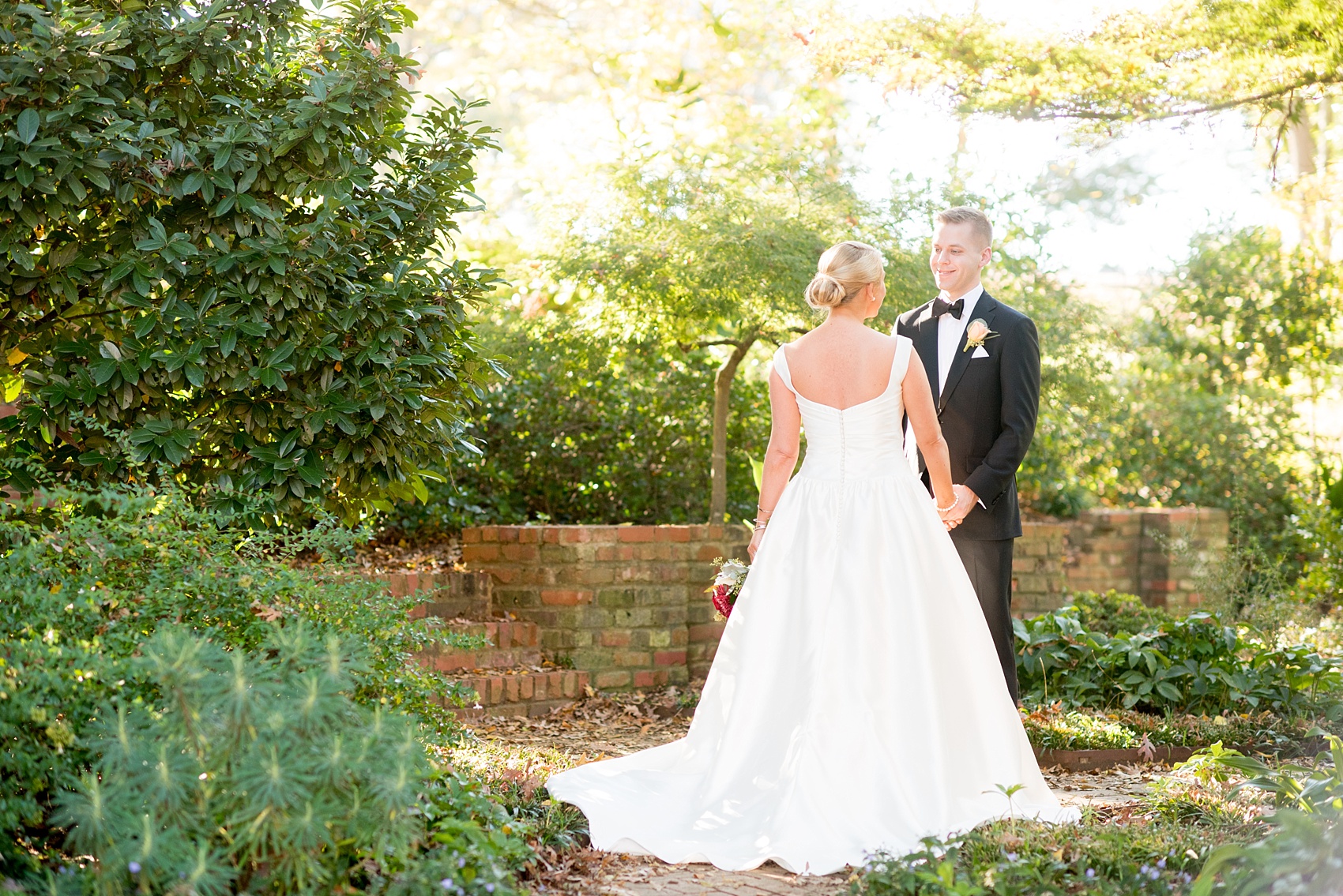 Mikkel Paige Photography photo of a wedding at The Rickhouse, North Carolina. Pictures of the bride and groom after their first look in Durham Central Park.