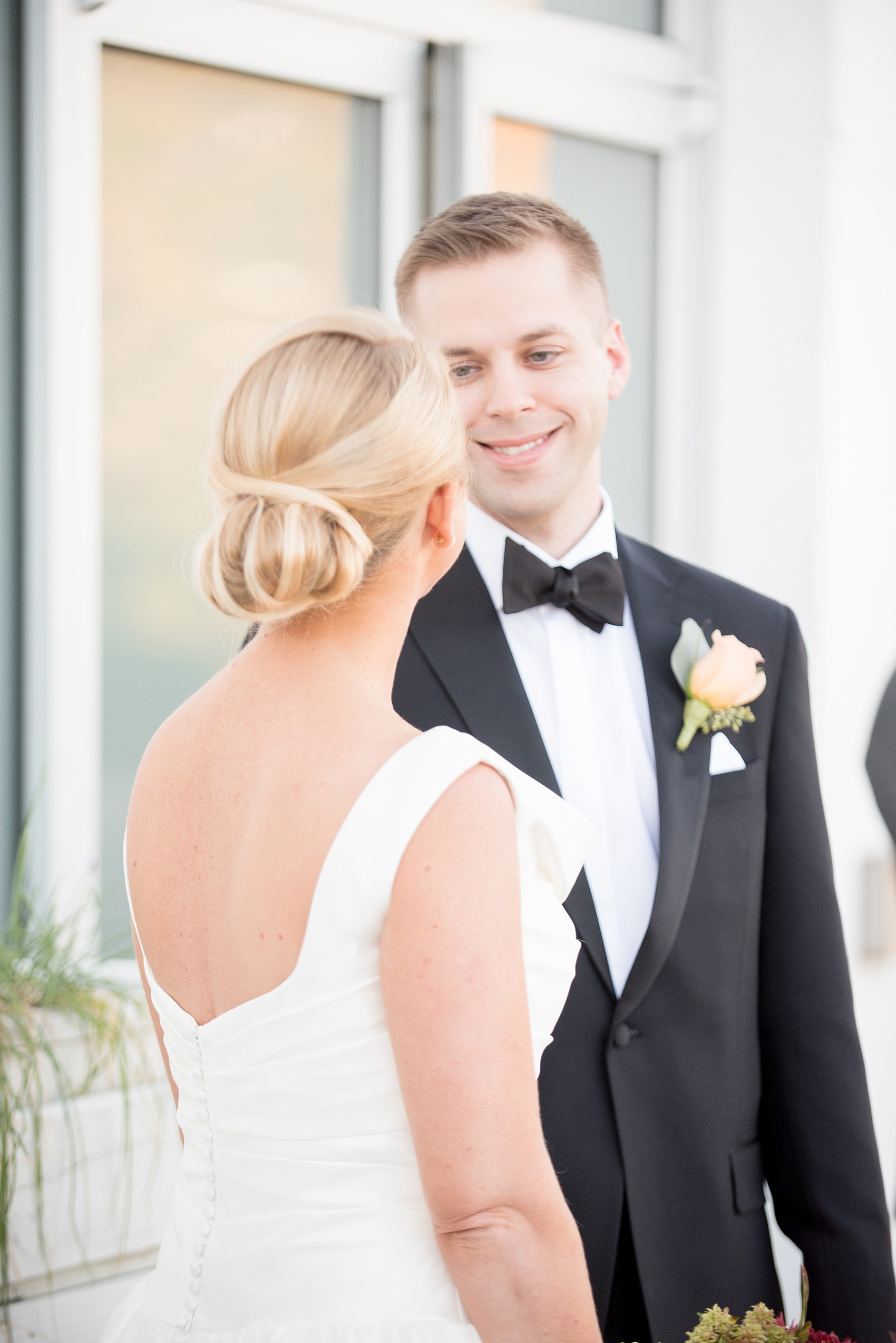 Mikkel Paige Photography photo of a wedding at The Rickhouse, North Carolina. Pictures of the bride and groom with the bride's unique up-hair-do.