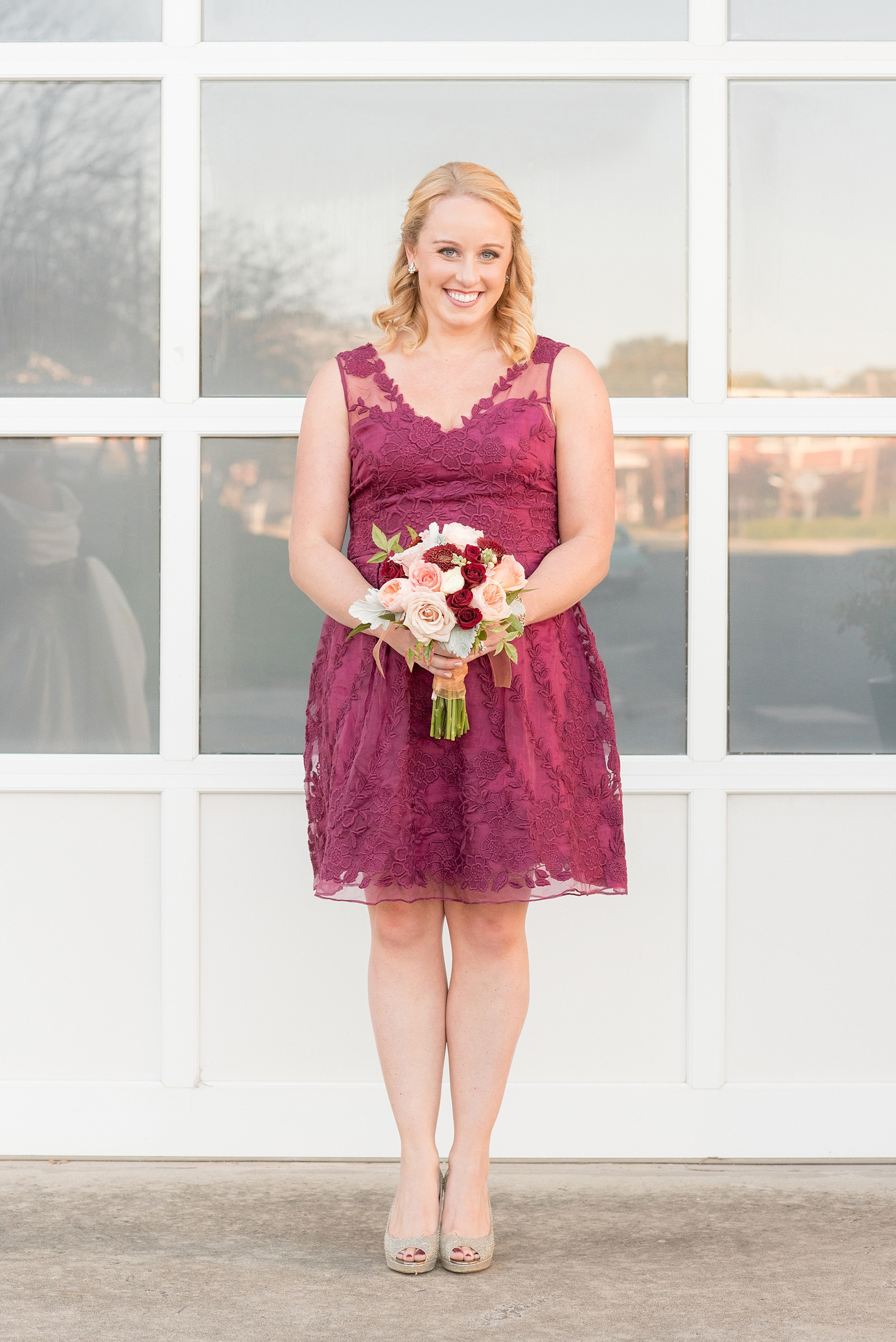 Mikkel Paige Photography photo of a wedding at The Rickhouse, Durham. The maid of honor/bridesmaid wore a short lace burgundy dress and carried an antique fall bouquet.