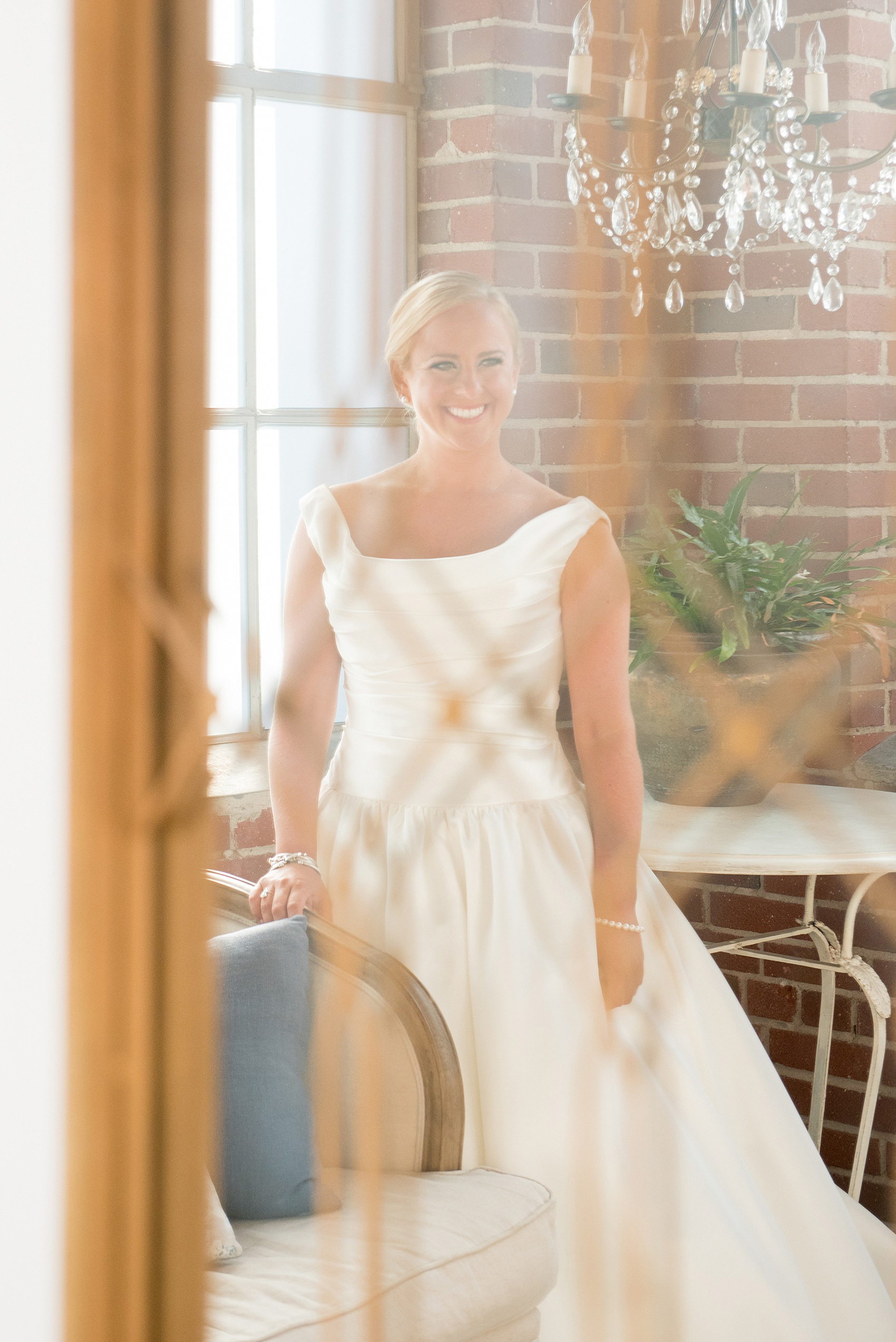 Mikkel Paige Photography photo of a wedding at The Rickhouse, Durham. A picture of the bride's reflection in an interesting mirror in the bridal suite.