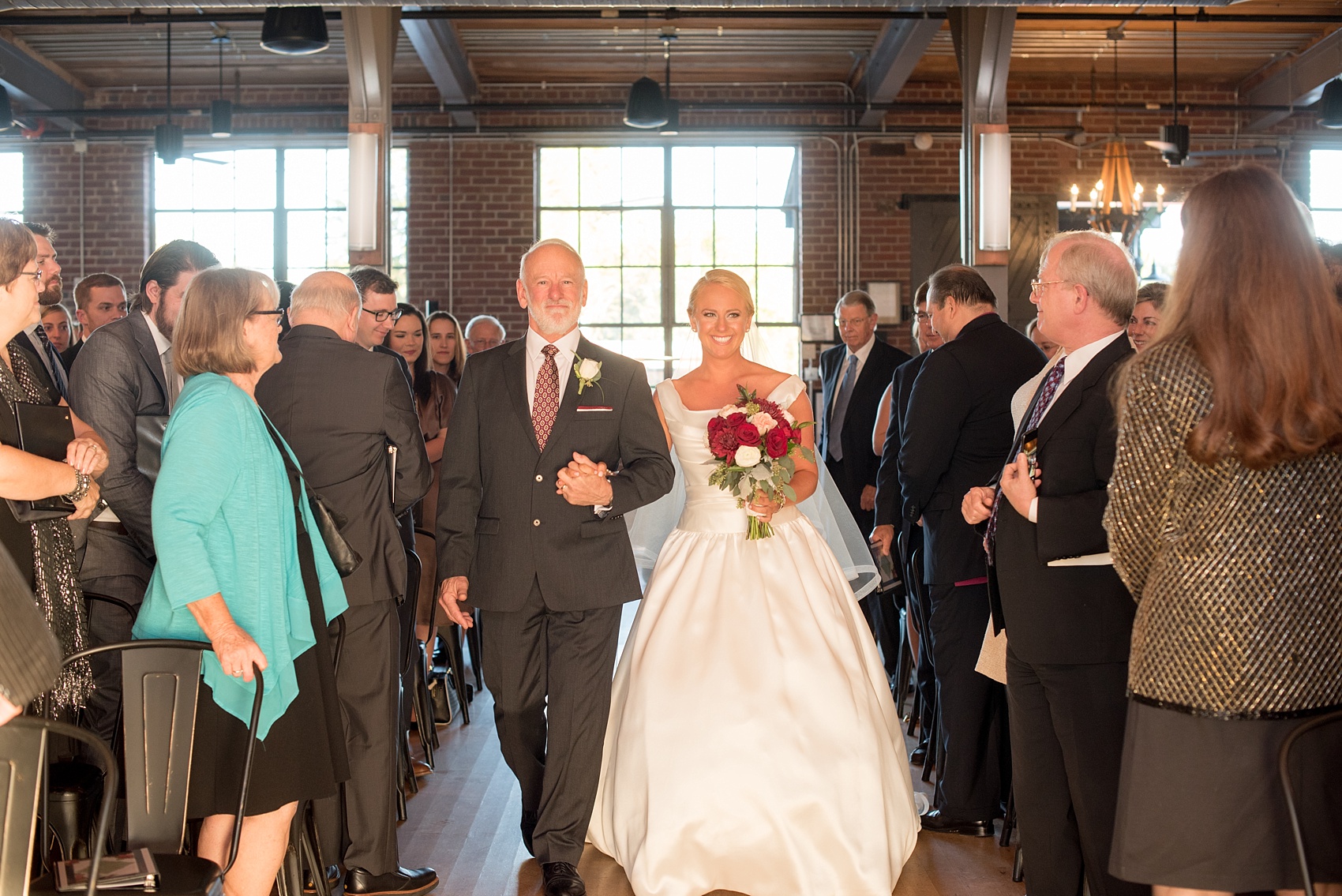 Mikkel Paige Photography photo of a wedding at The Rickhouse, Durham. A picture of the bride and her father walking down the aisle.