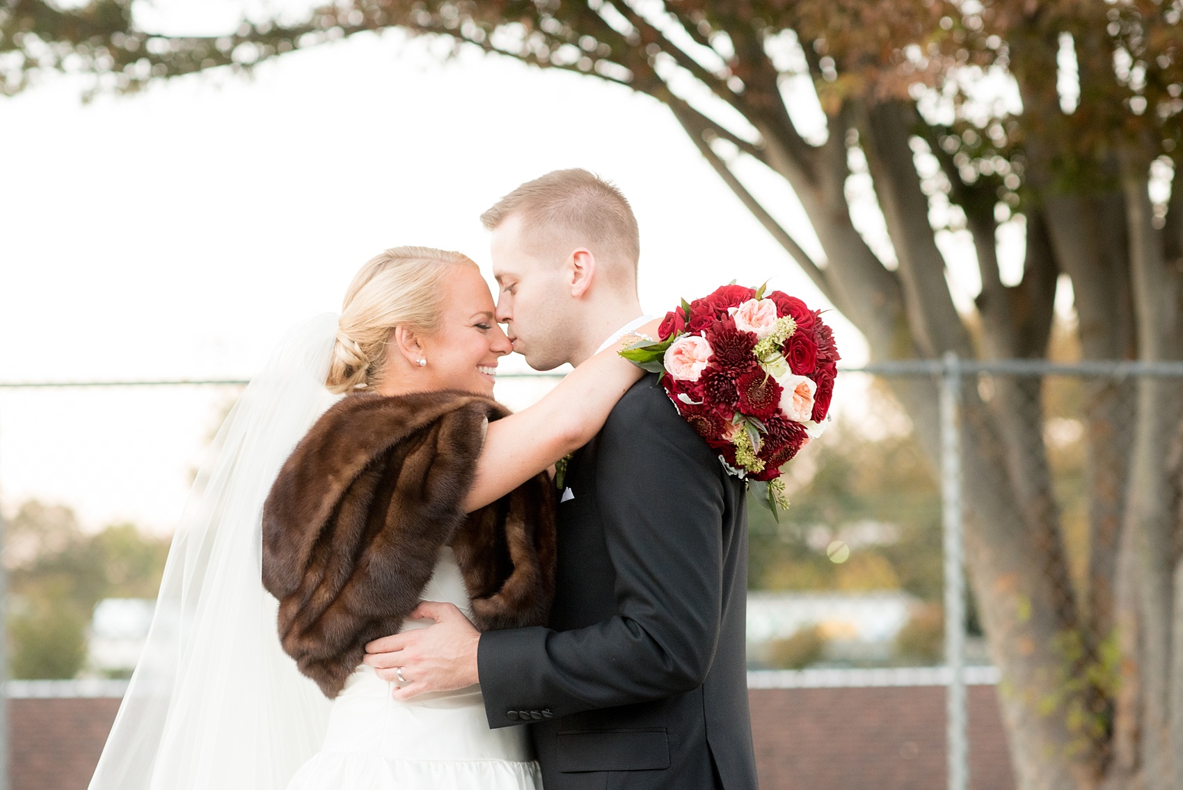 Mikkel Paige Photography photo of a wedding at The Rickhouse, NC. A picture of bride's heirloom fur stahl for her fall wedding with her grandmother's name embroidered in it.