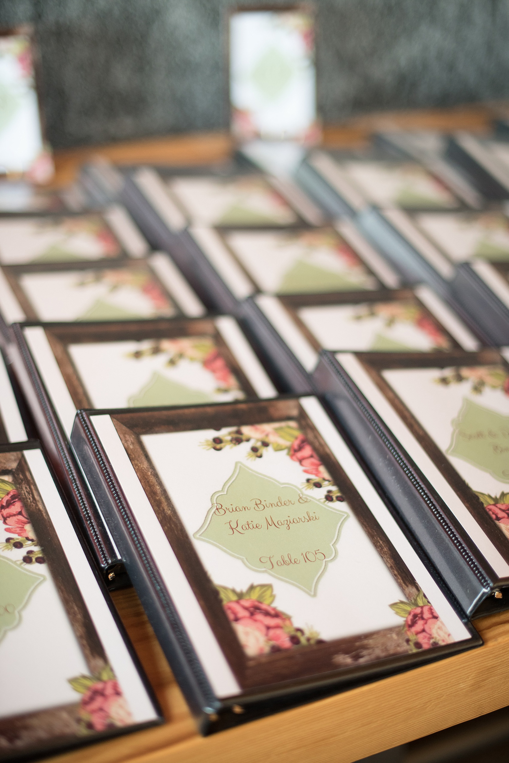 Mikkel Paige Photography photo of a wedding at The Rickhouse, NC. A picture of their escort card alternative binders with information on the evening program and table number meanings.