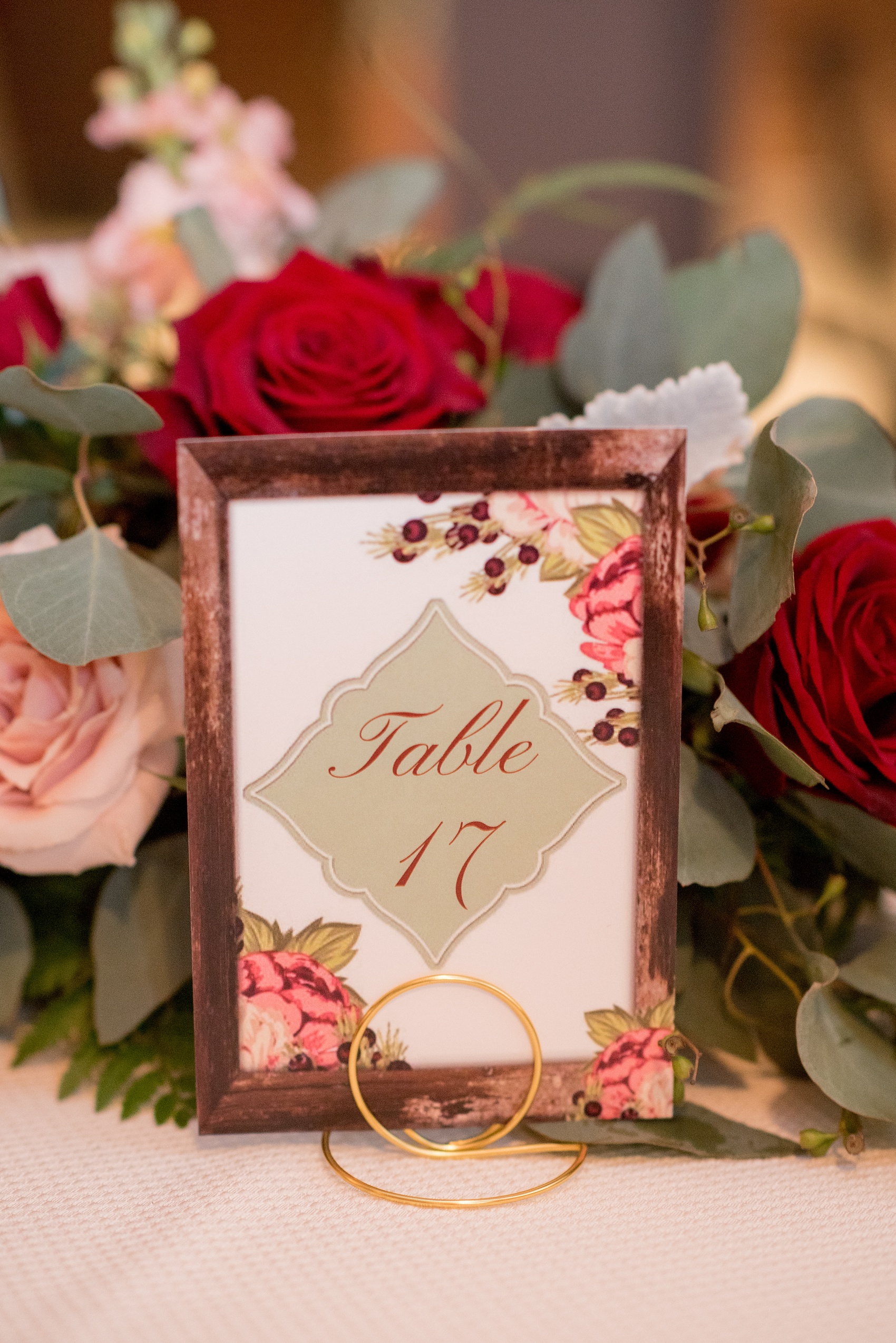 Mikkel Paige Photography photo of a wedding at The Rickhouse, NC. A picture of the their fall inspired shabby chic table numbers.