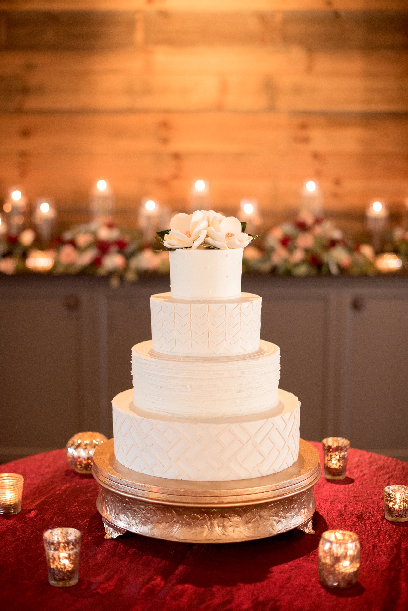 Mikkel Paige Photography photo of a wedding at The Rickhouse, NC. A picture of the white tiered fondant wedding cake topped with gumpaste magnolia sugar flowers.