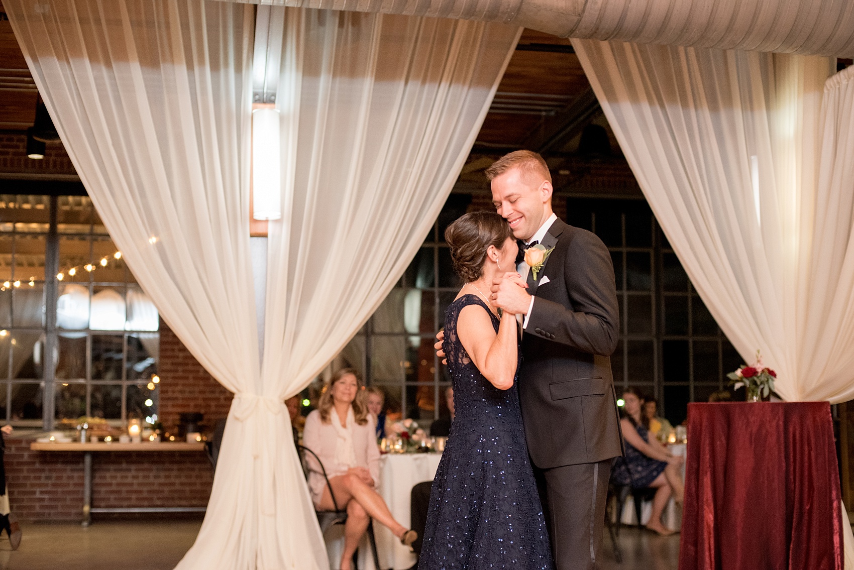 Mikkel Paige Photography photo of a wedding at The Rickhouse, NC. A picture of the groom dancing with his mother.