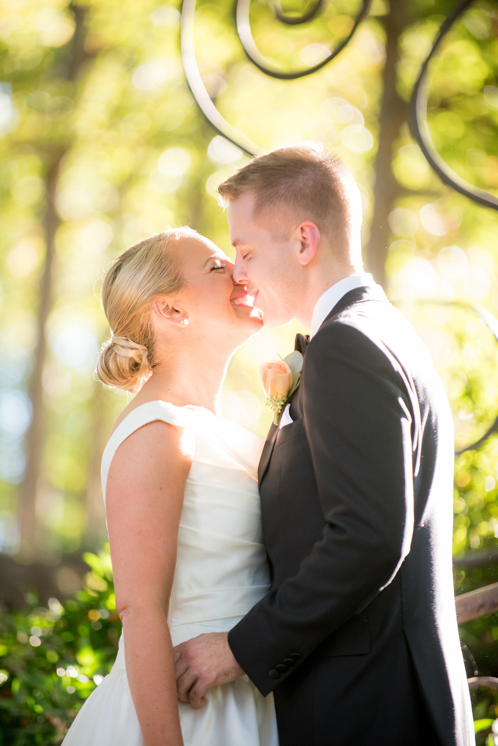 Mikkel Paige Photography photo of a wedding at The Rickhouse, North Carolina. The bride and groom kiss in Durham Central Park after their first look! 