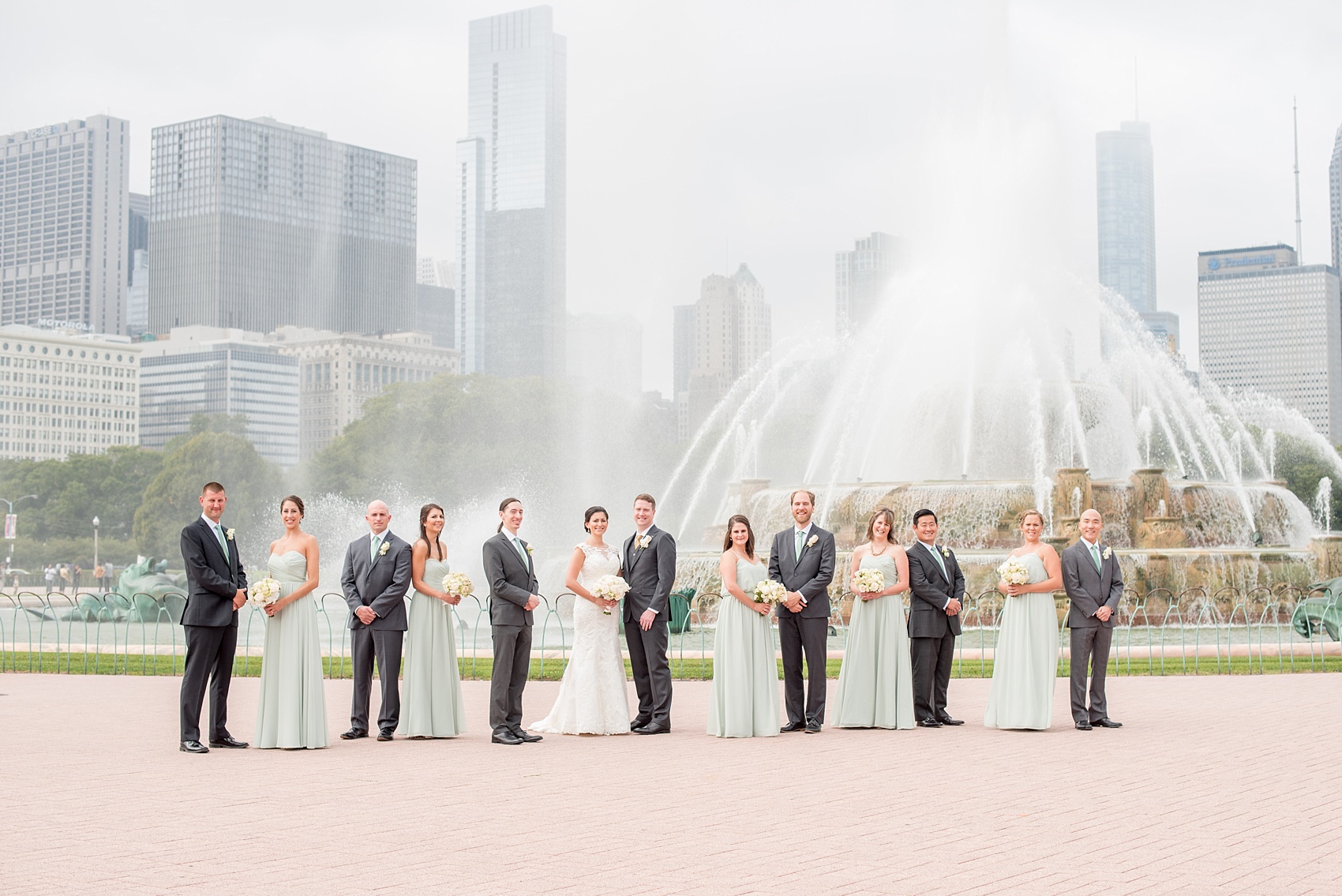 Mikkel Paige Photography photos of a wedding in downtown Chicago at The Rookery, with the bridal party in mint green by Buckingham Fountain.