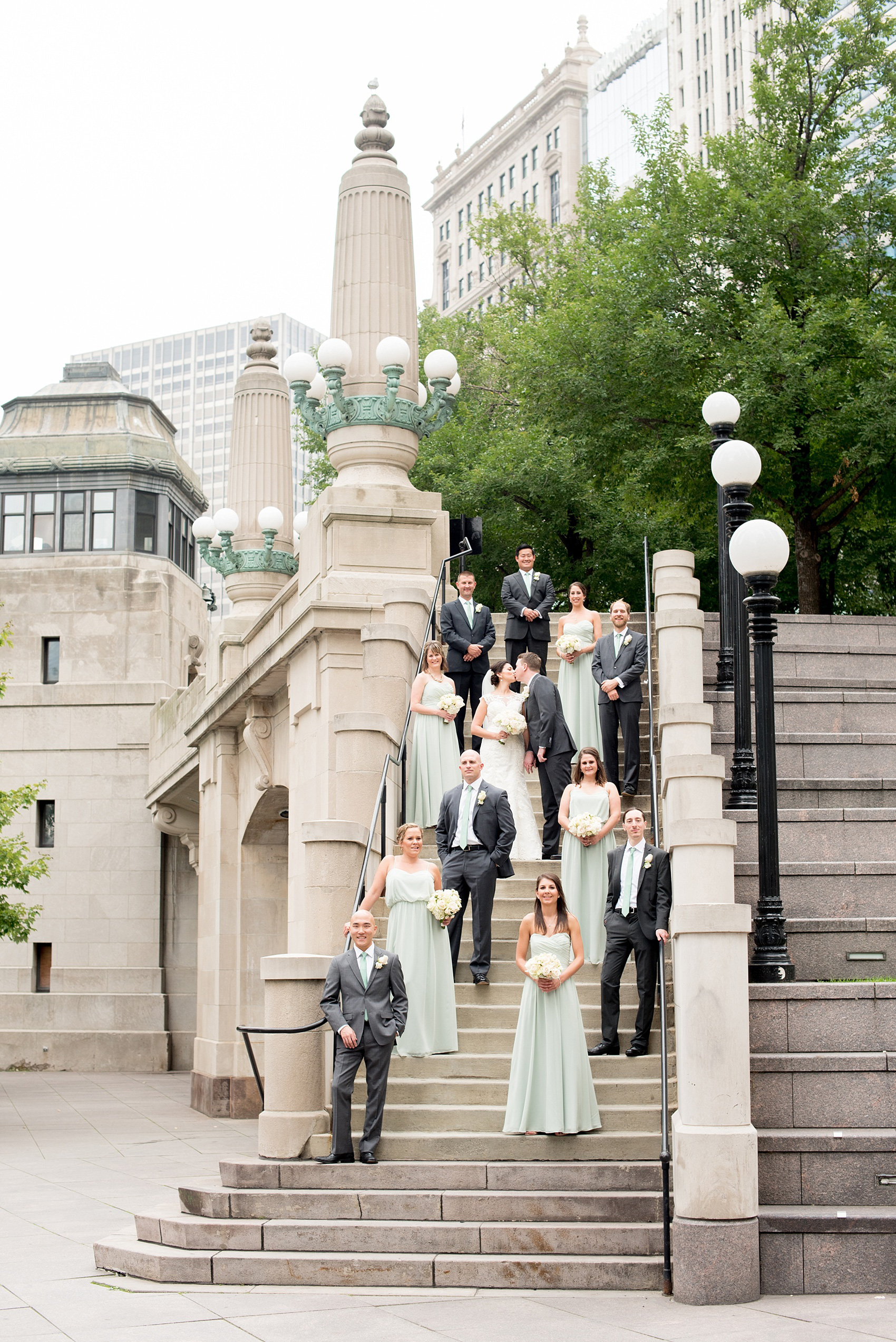 Mikkel Paige Photography photos of a wedding in downtown Chicago at The Rookery. Iconic, unique images of the bridal party in mint green and groomsmen in grey suits for wedding party pictures on Riverwalk.