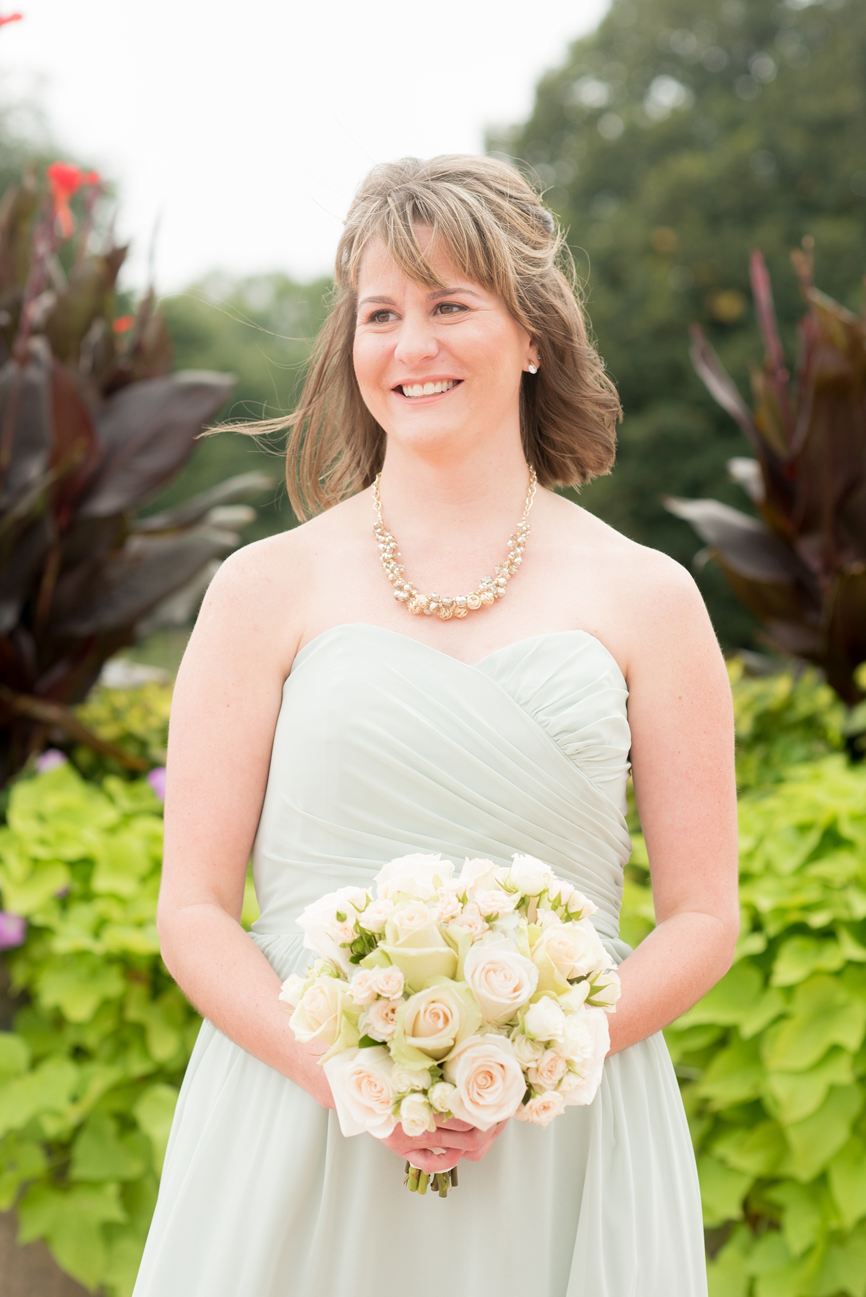 Mikkel Paige Photography photos of a wedding in downtown Chicago at The Rookery. The bridesmaids wore mint green Alfred Angelo gowns and held white and green rose bouquets.