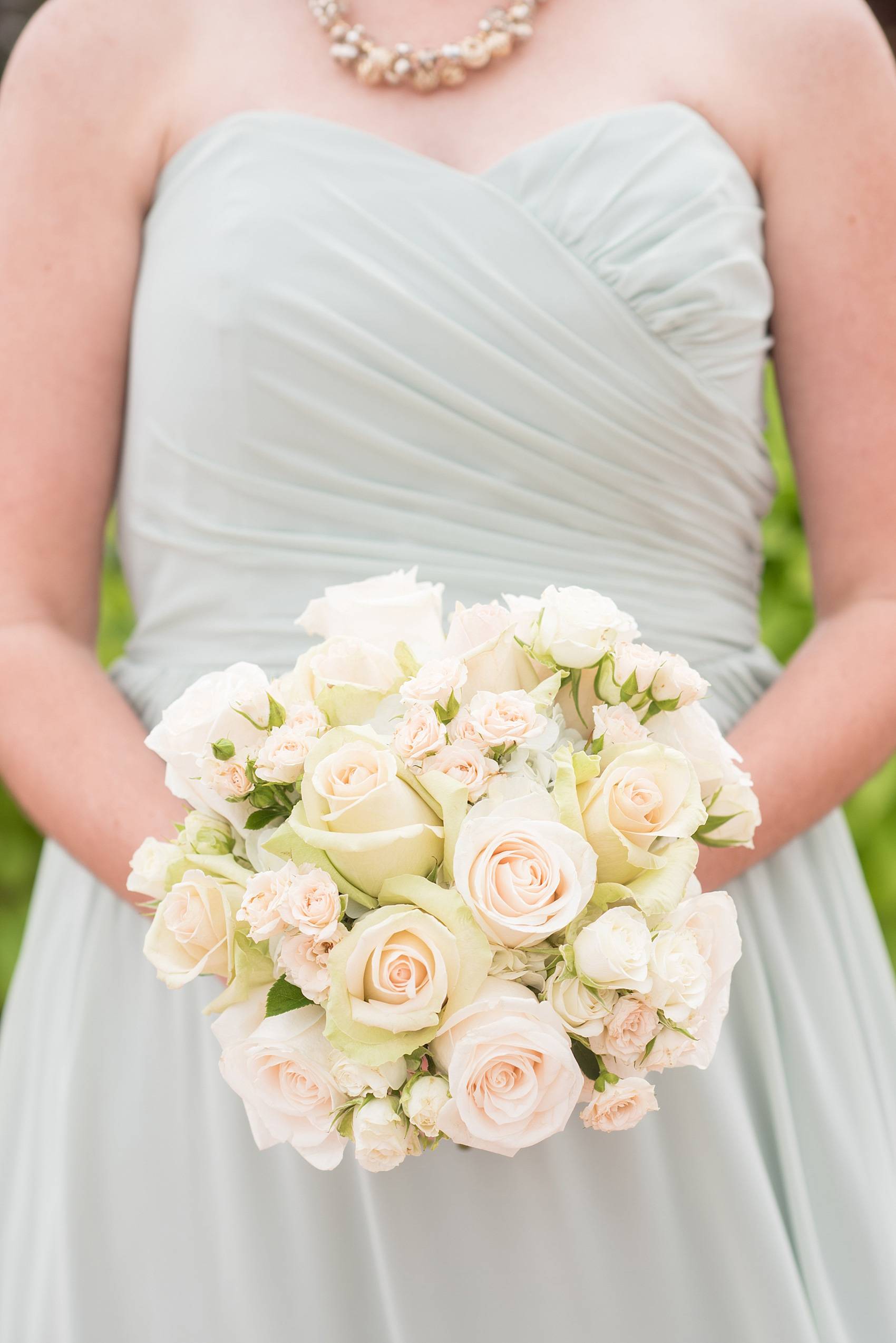 Mikkel Paige Photography photos of a wedding in downtown Chicago at The Rookery. The bridesmaids wore mint green Alfred Angelo gowns and held white and green rose bouquets.