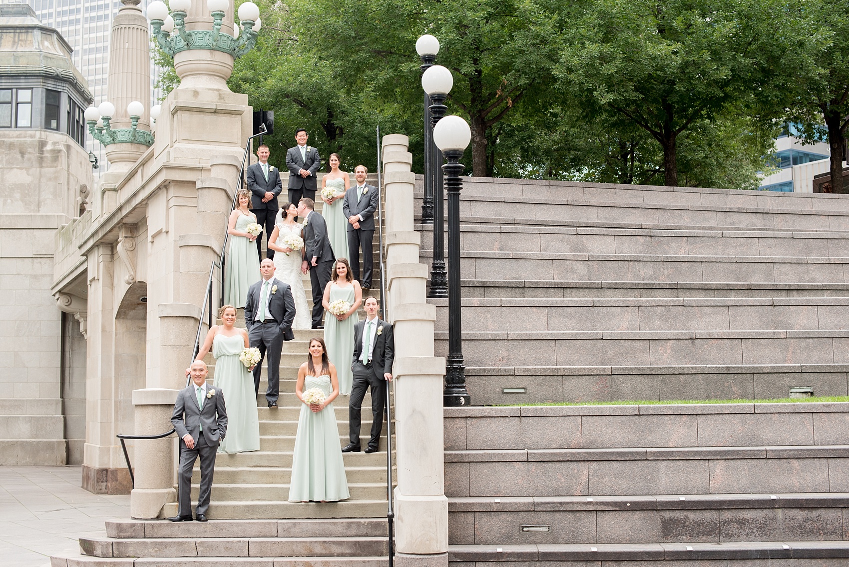 Mikkel Paige Photography photos of a wedding in downtown Chicago at The Rookery. Iconic, unique images of the bridal party in mint green and groomsmen in grey suits for wedding party pictures on Riverwalk.