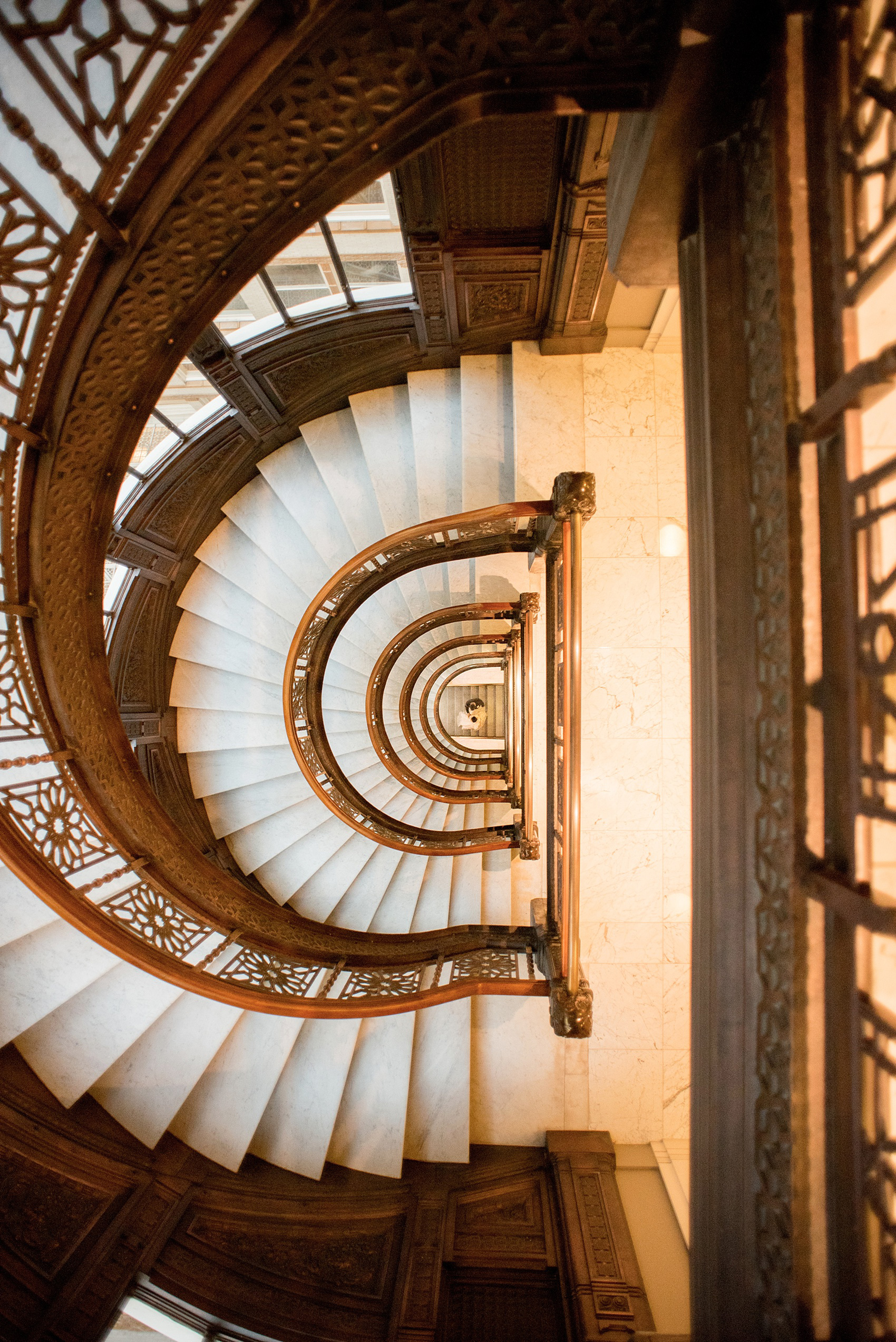 Mikkel Paige Photography photos of a wedding in downtown Chicago at The Rookery. The venue's white marble spiral staircase was perfect for unique bride and groom pictures.