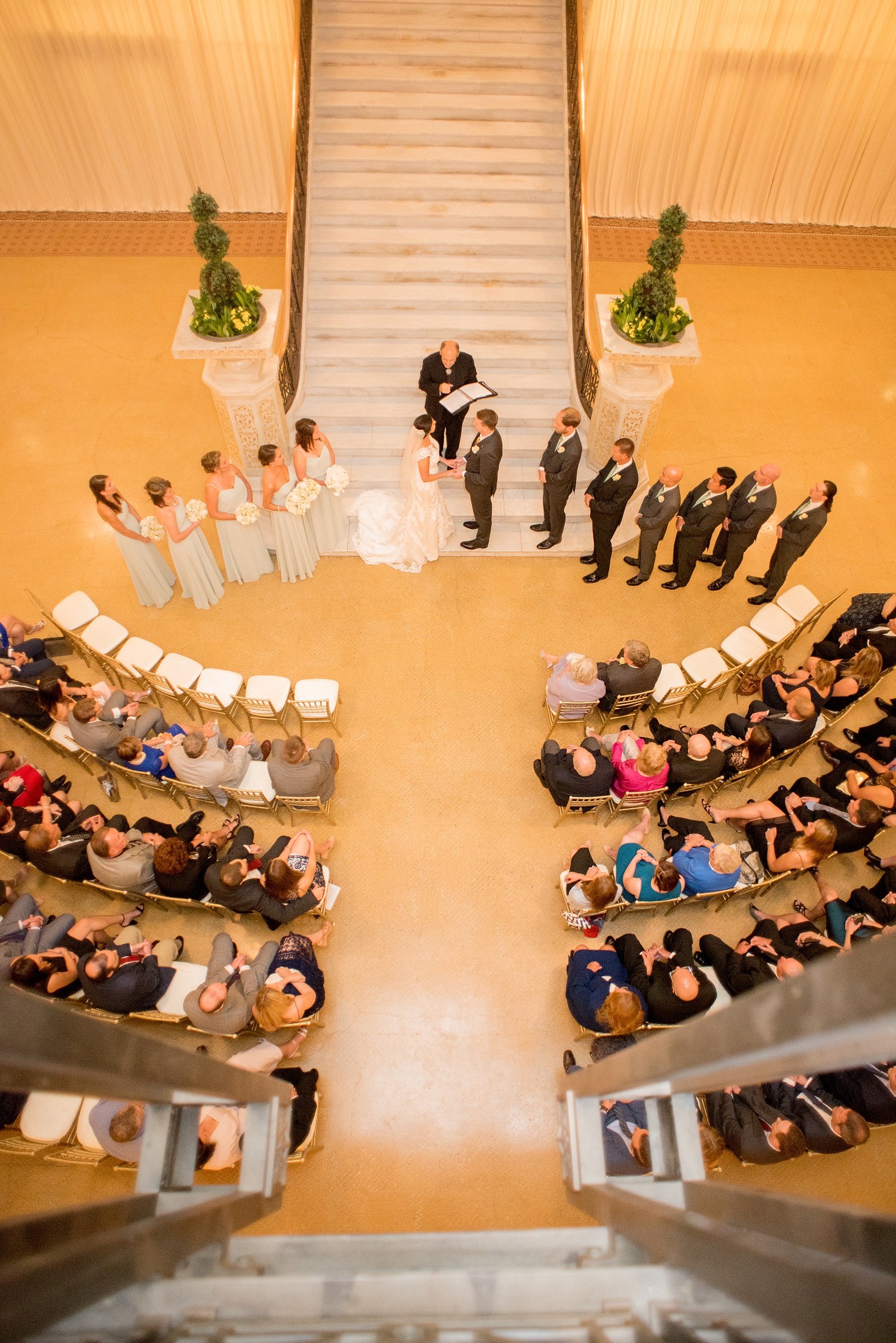 Mikkel Paige Photography photos of a wedding in downtown Chicago at The Rookery. The marble staircase served as the ceremony backdrop.