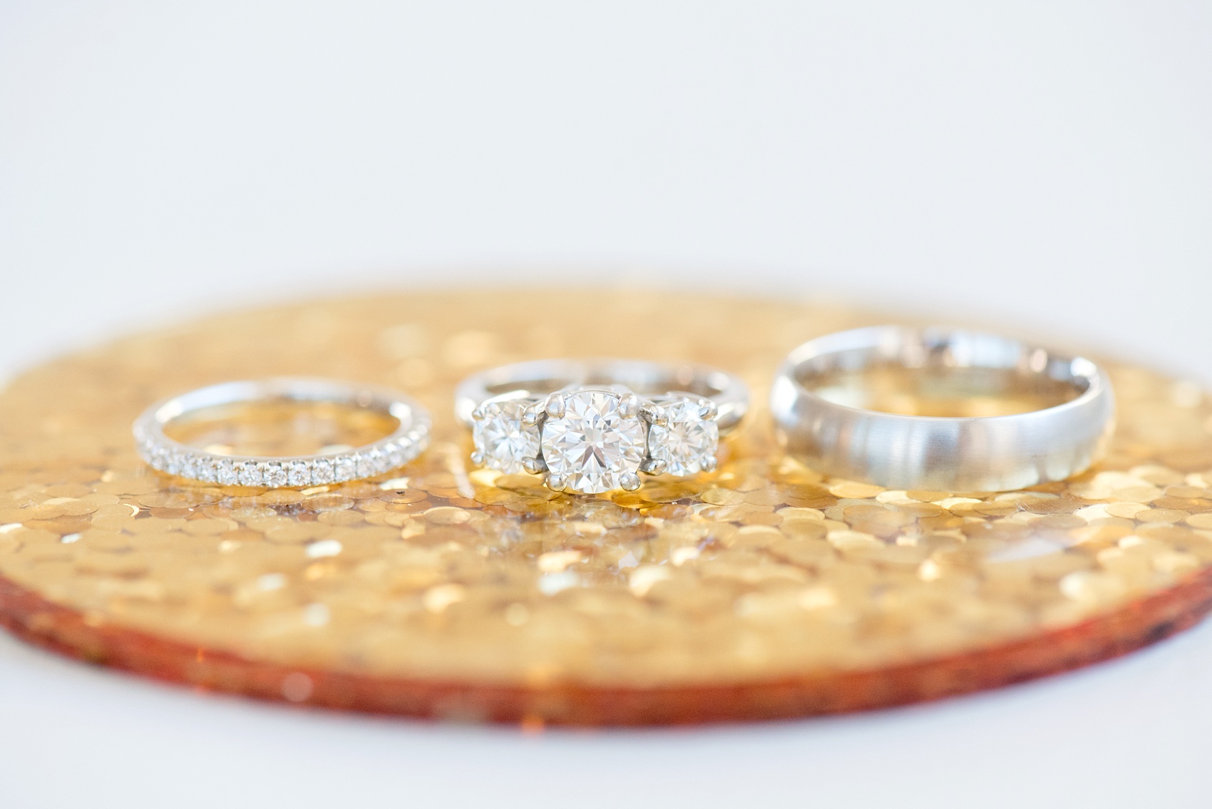Mikkel Paige Photography photos from a wedding at The Glass Box and Stockroom at 230 in Raleigh. A detail image of the bride's three stone engagement ring.